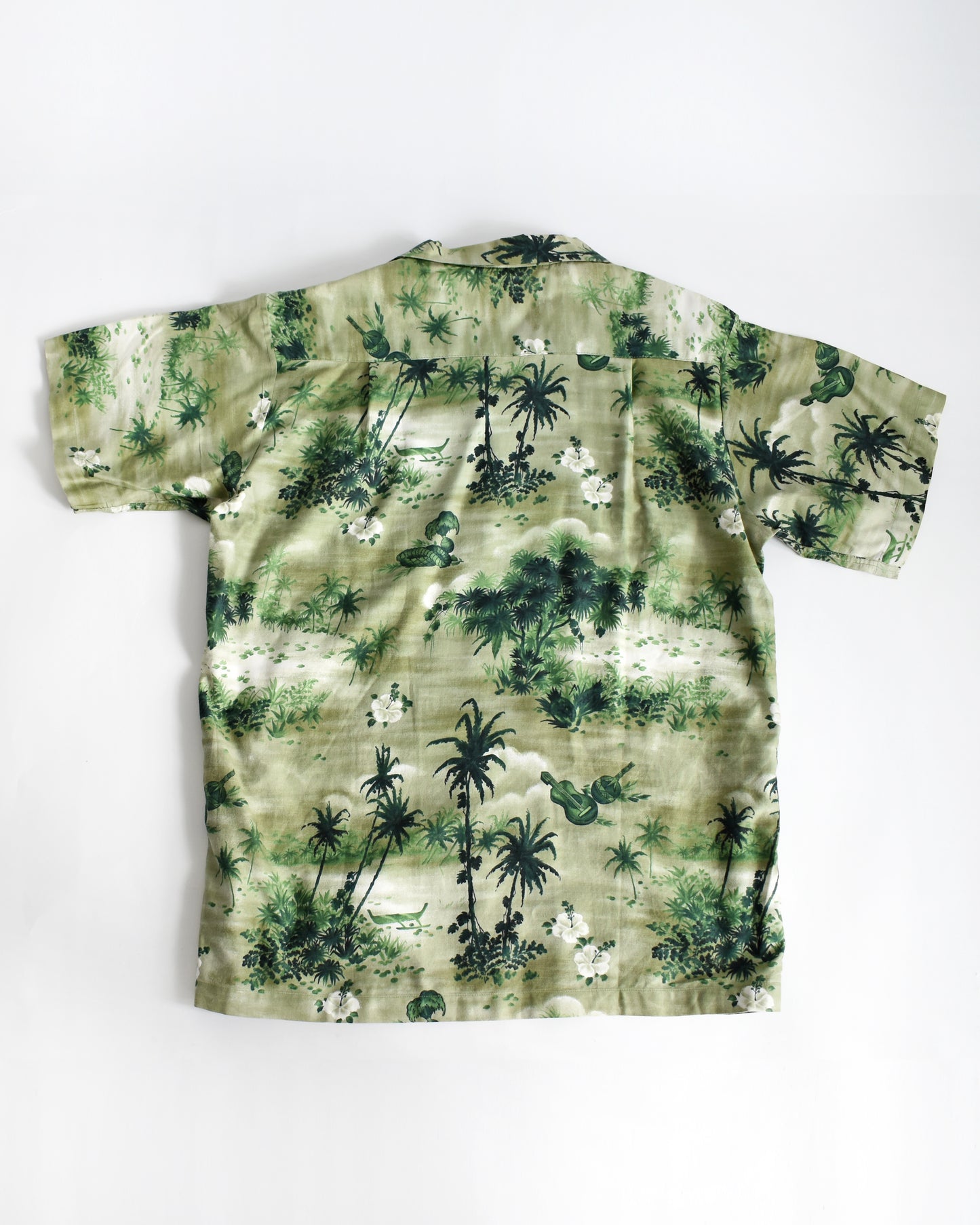 back view of a vintage 1950s green Hawaiian shirt by Royal Hawaiian on a white background