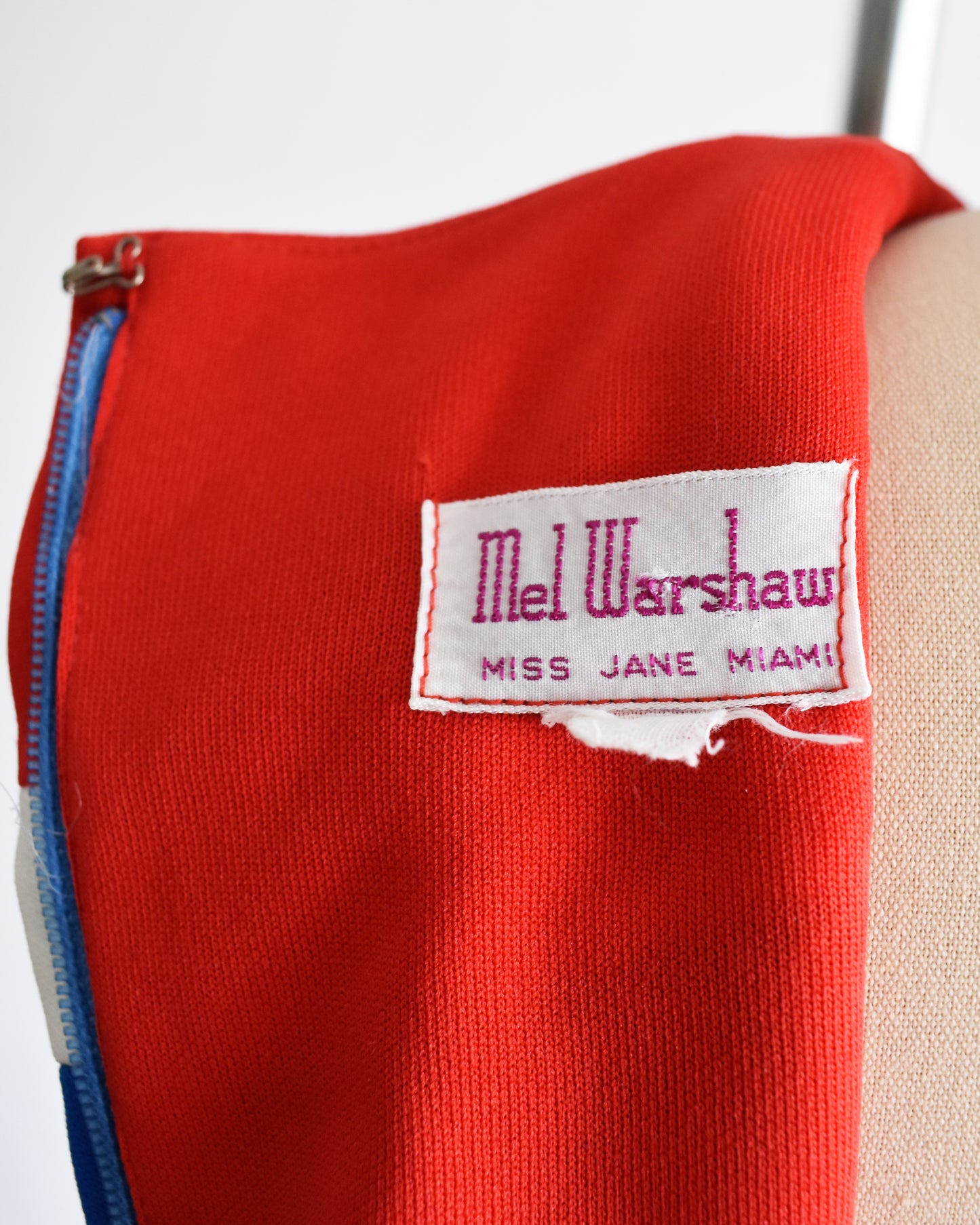 close up of the label reading 'Mel Warshaw Miss Jane Miami' on a white background