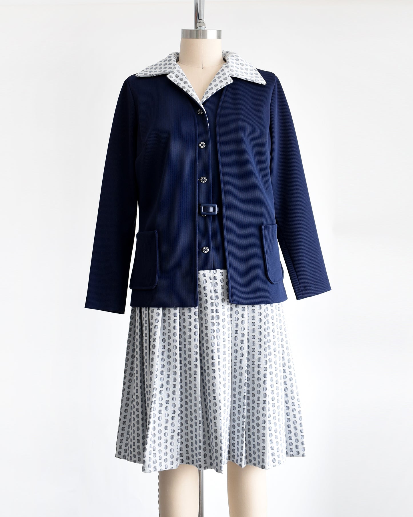a vintage 1970s mod two piece set which features a navy blue jacket and matching dress