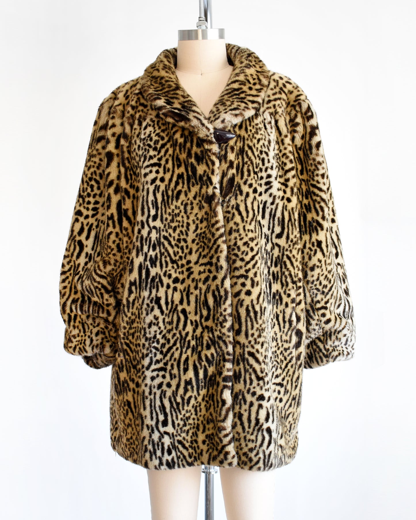 a vintage 1970s faux fur leopard print coat