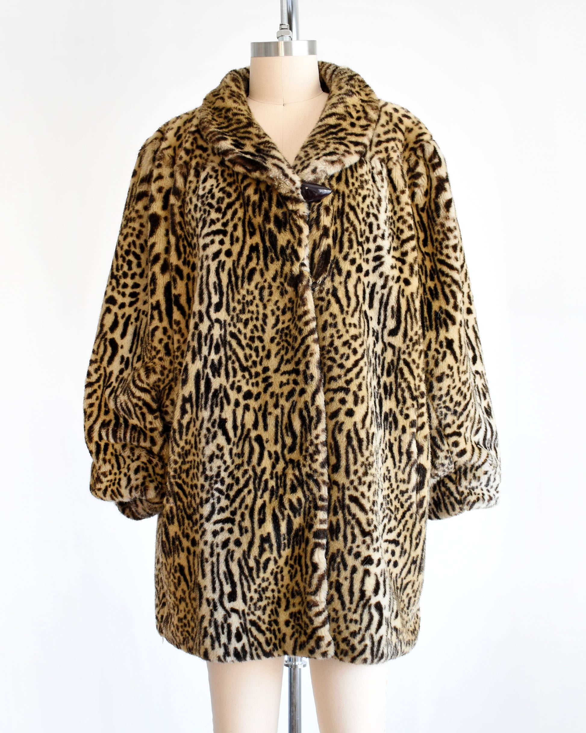 a vintage 1970s faux fur leopard print coat
