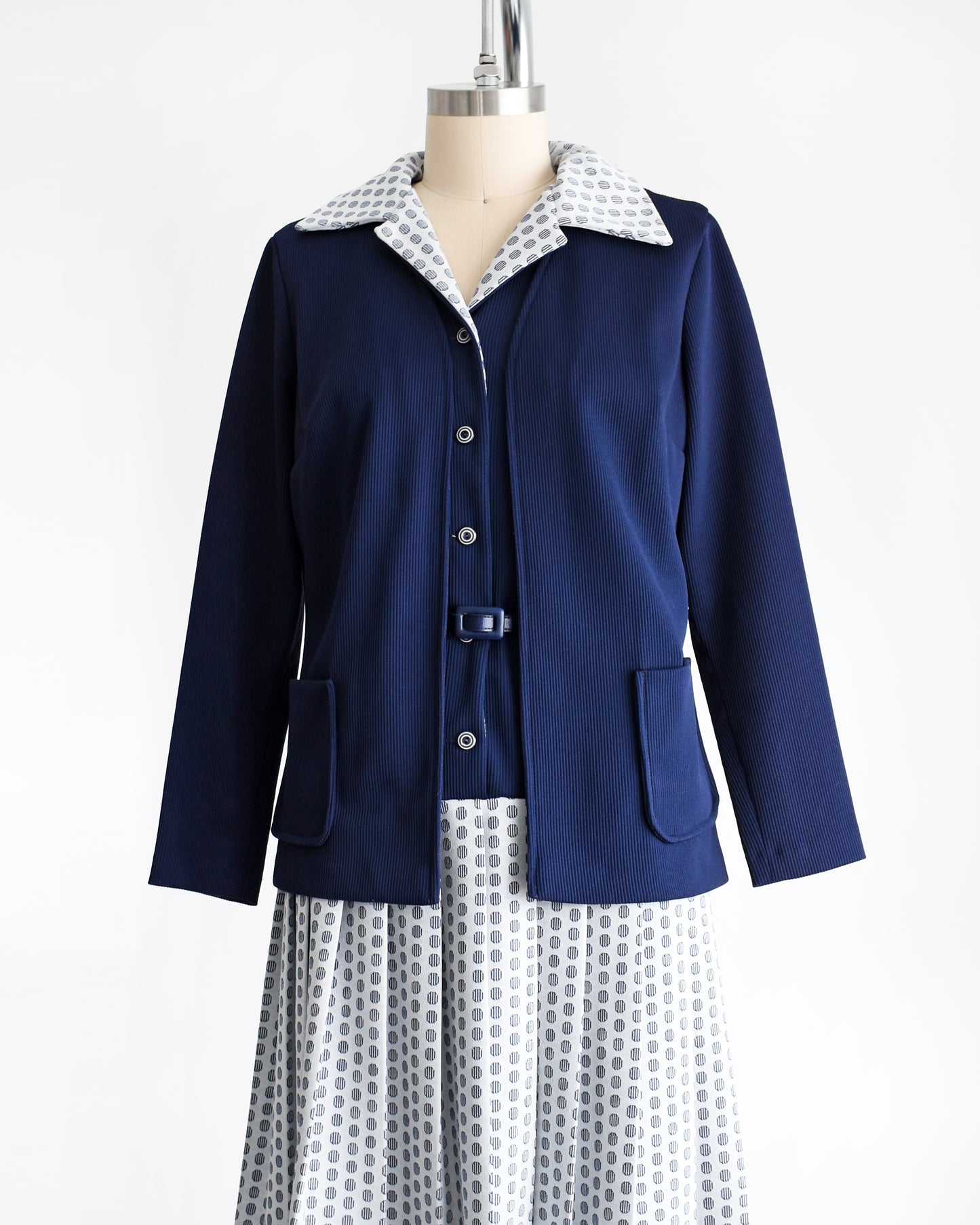 side front view of a vintage 1970s mod two piece set which features a navy blue jacket and matching dress