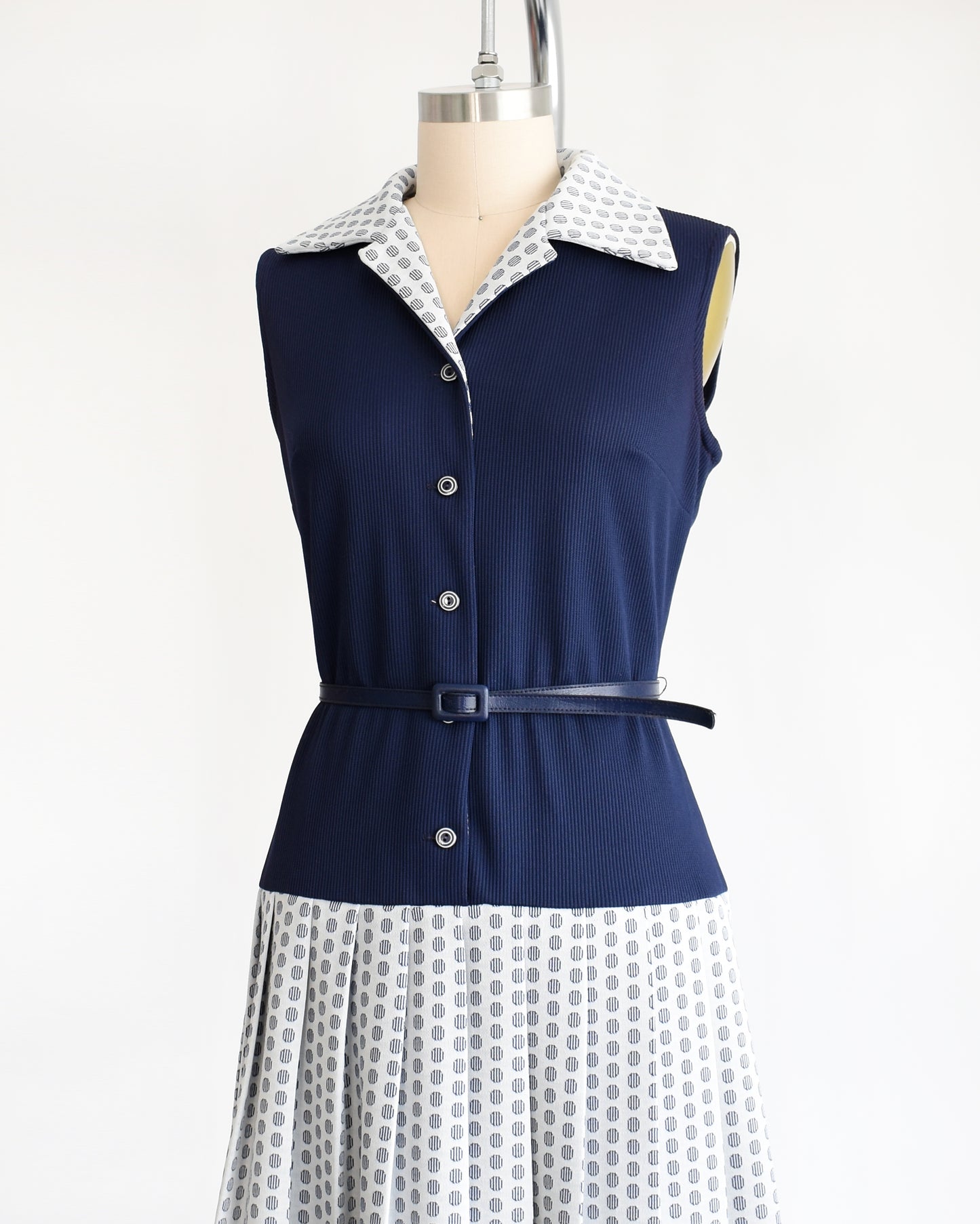 side front view of a vintage 1970s mod two piece set which features a navy blue jacket and matching dress