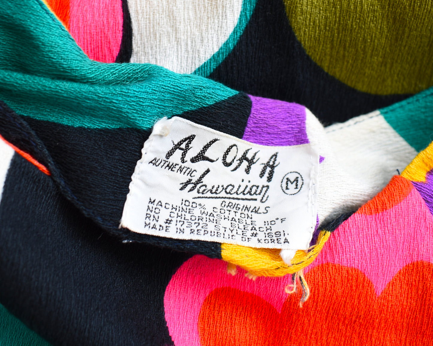 Close up of the tag that says Aloha Authentic Hawaiian Originals
