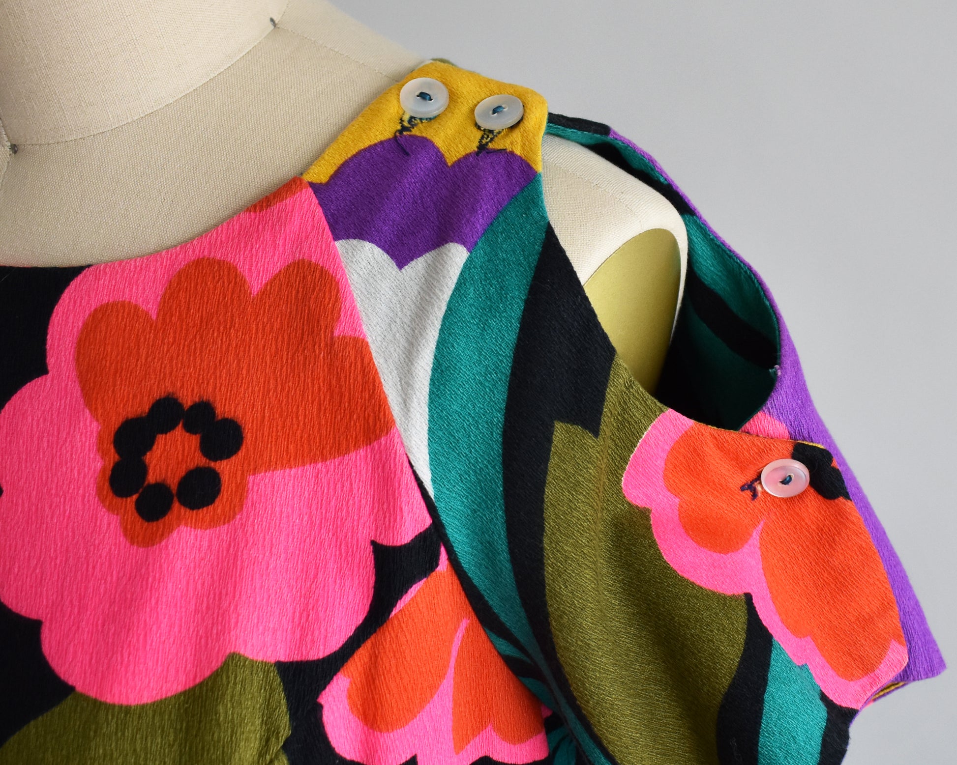 Close up of the could shoulder, which has two buttons on the top of the shoulder and one on the sleeve.