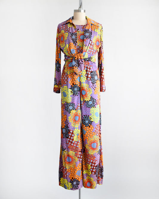 Vibrant vintage 1970 mod floral pantsuit three piece set. The blouse is tied at the waist in this photo