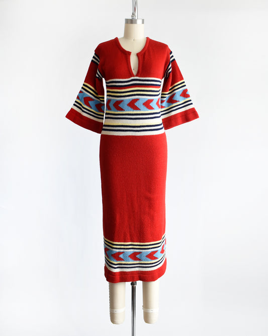 a vintage 1970s southwestern red sweater dress with a patterned bodice on a mannequin against a white background