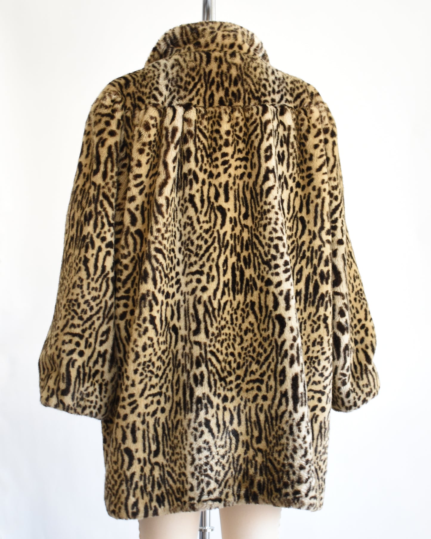 back view of a vintage 1970s faux fur leopard print coat