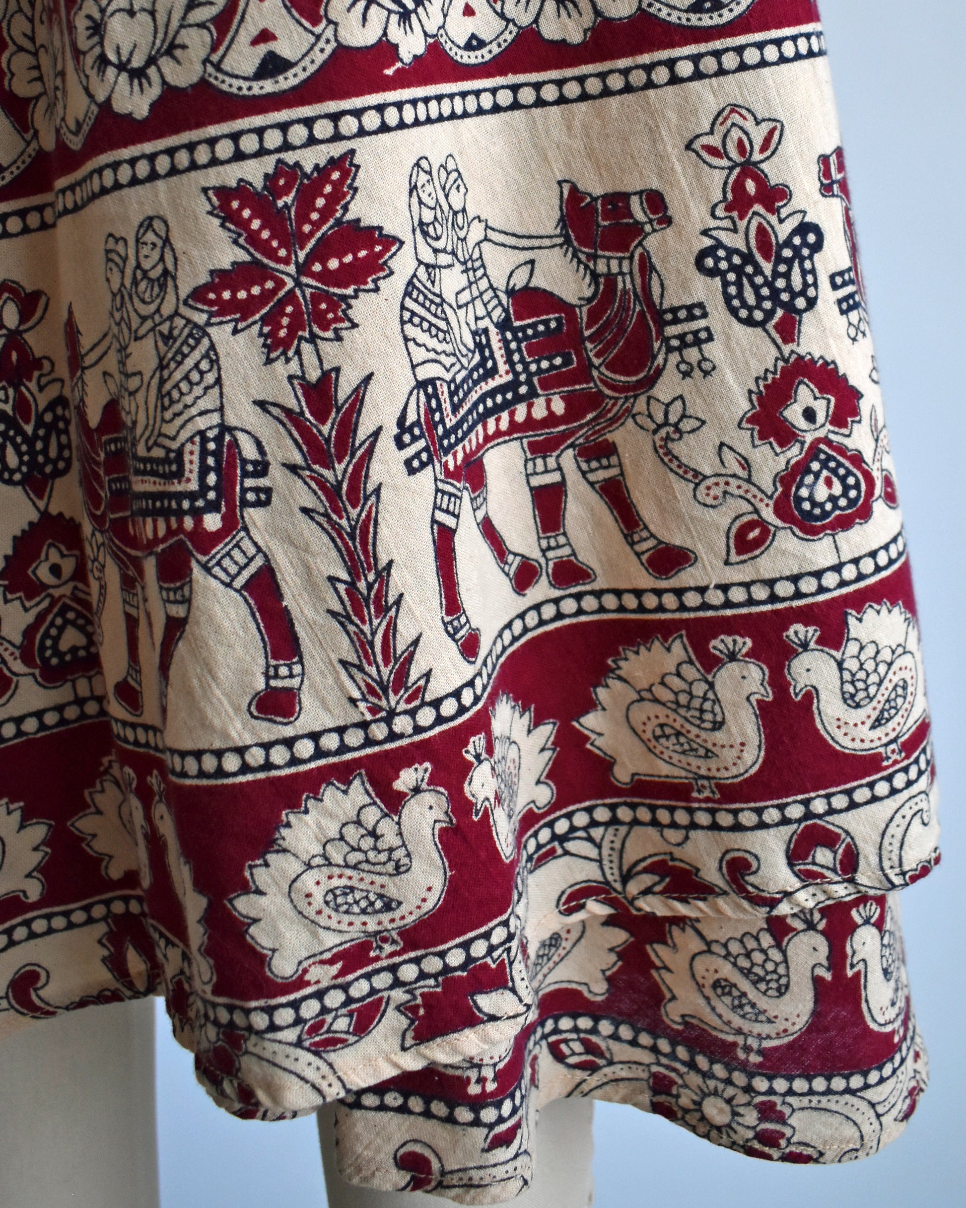 Close up of the camel riders and bird print near the hem
