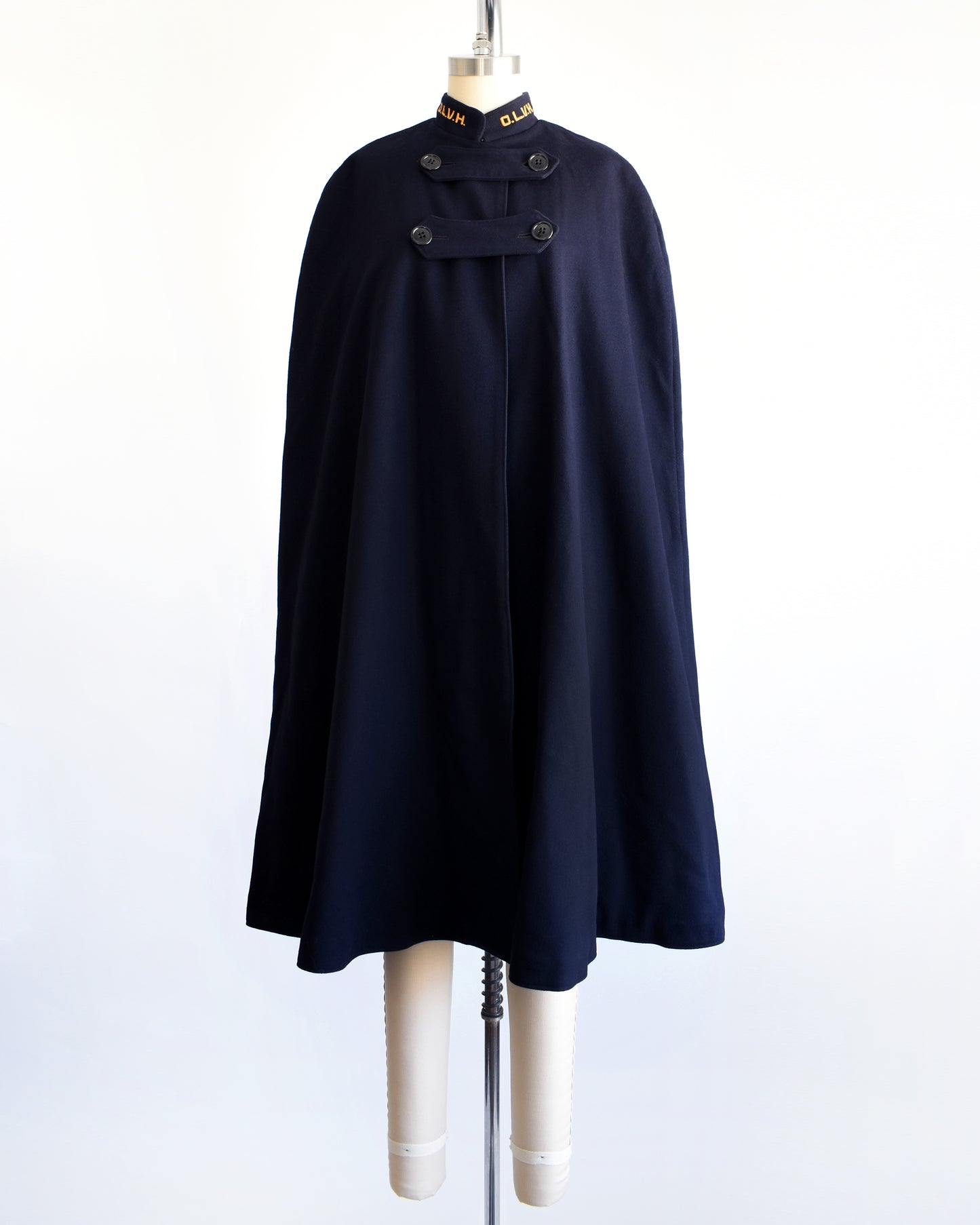 a vintage 1940s navy nurse's cape on a mannequin against a white background.