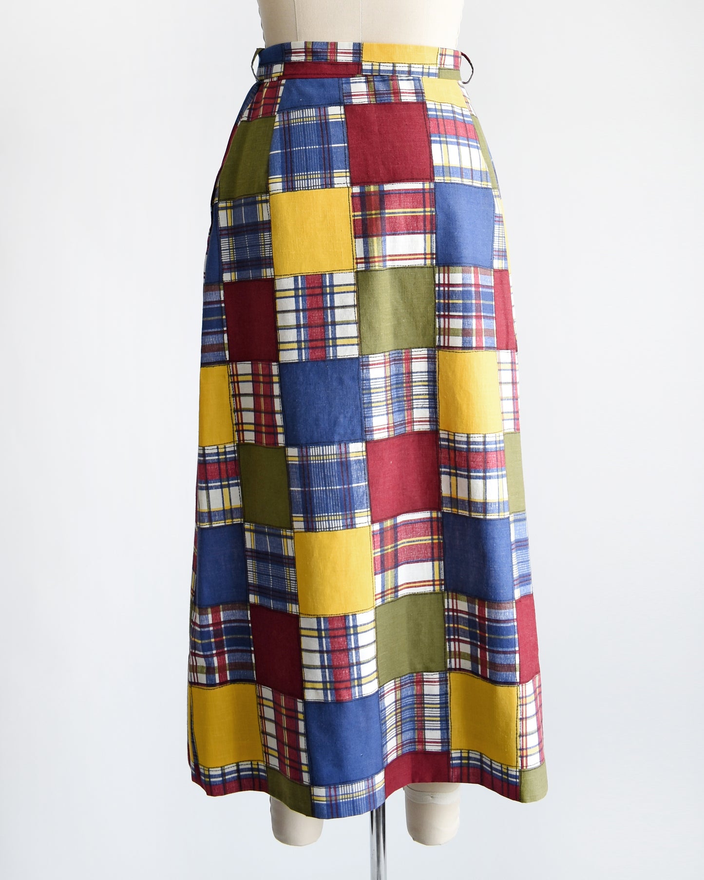 back view of a vintage 1970s patchwork madras plaid maxi skirt with matching tie belt