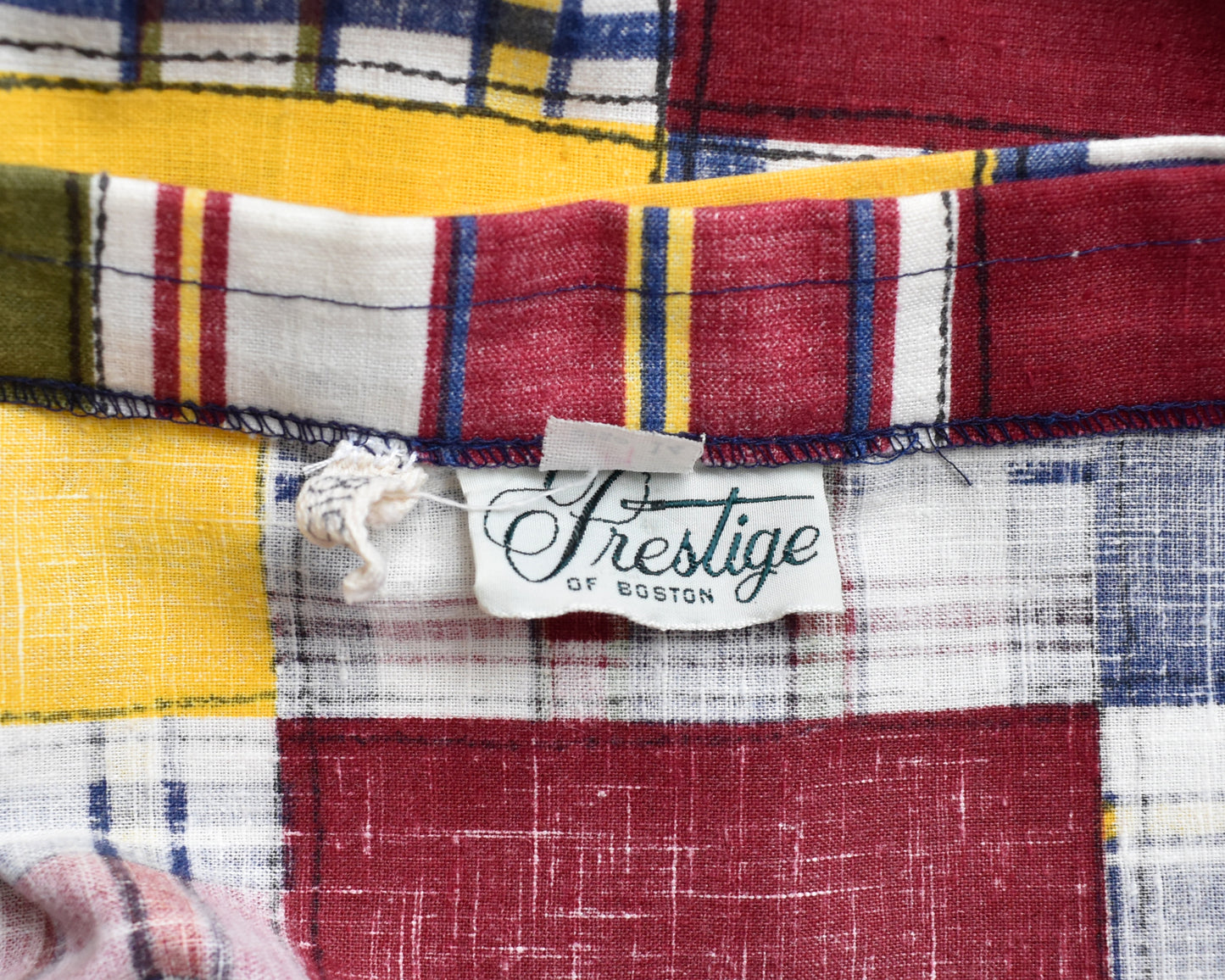 close up of the tag which says Prestige of Boston