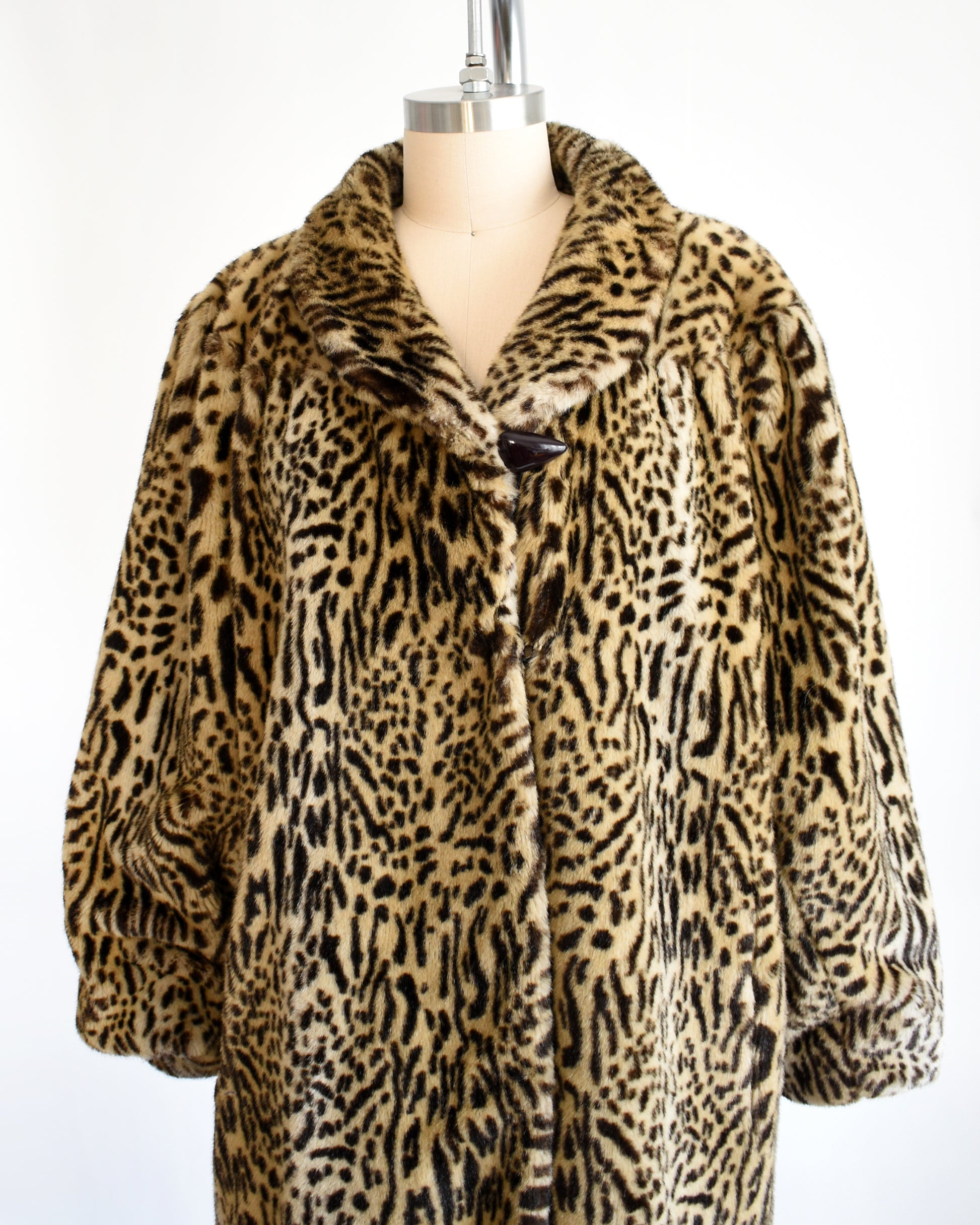 side front view of a vintage 1970s faux fur leopard print coat