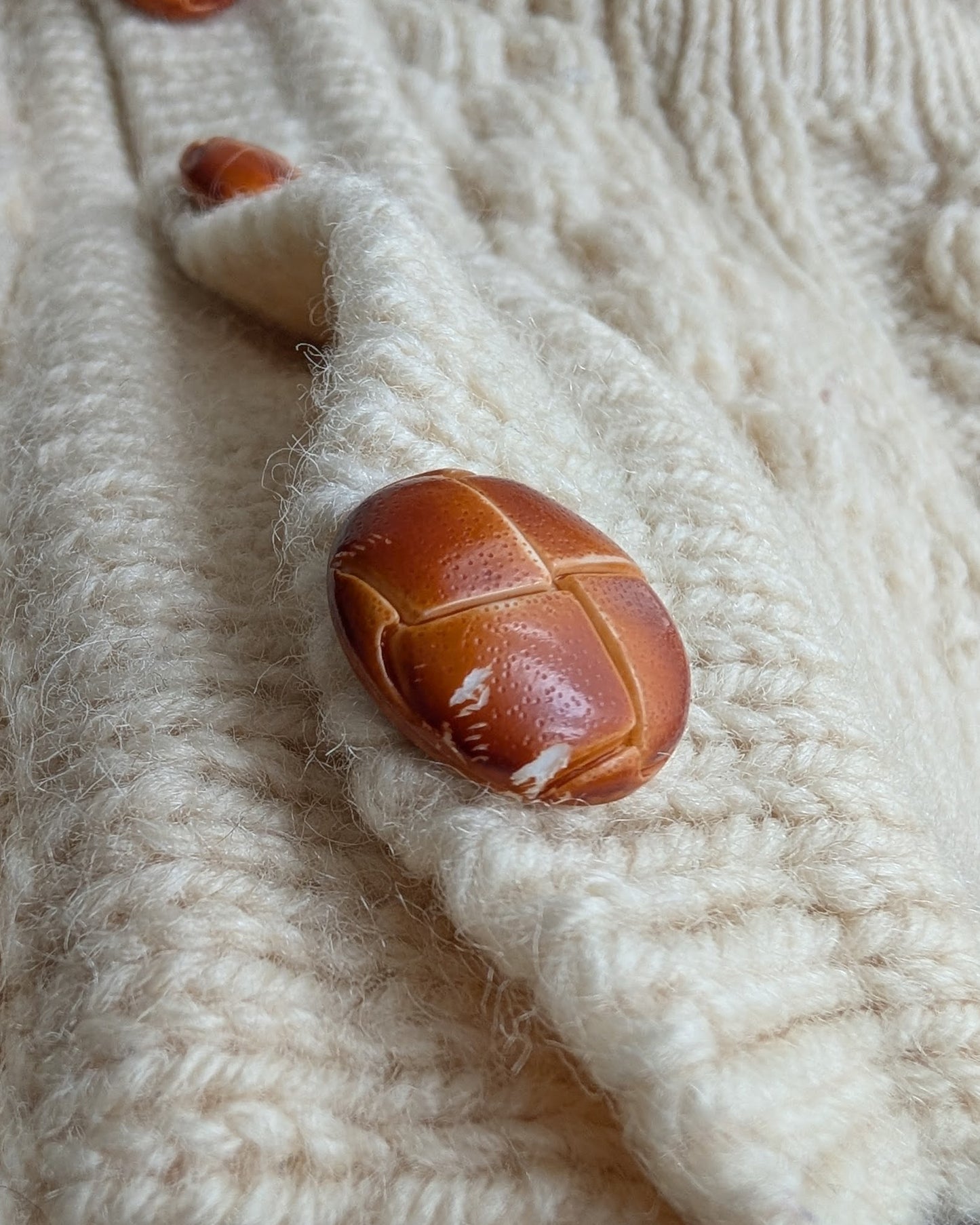 close up of small scrapes on the last button