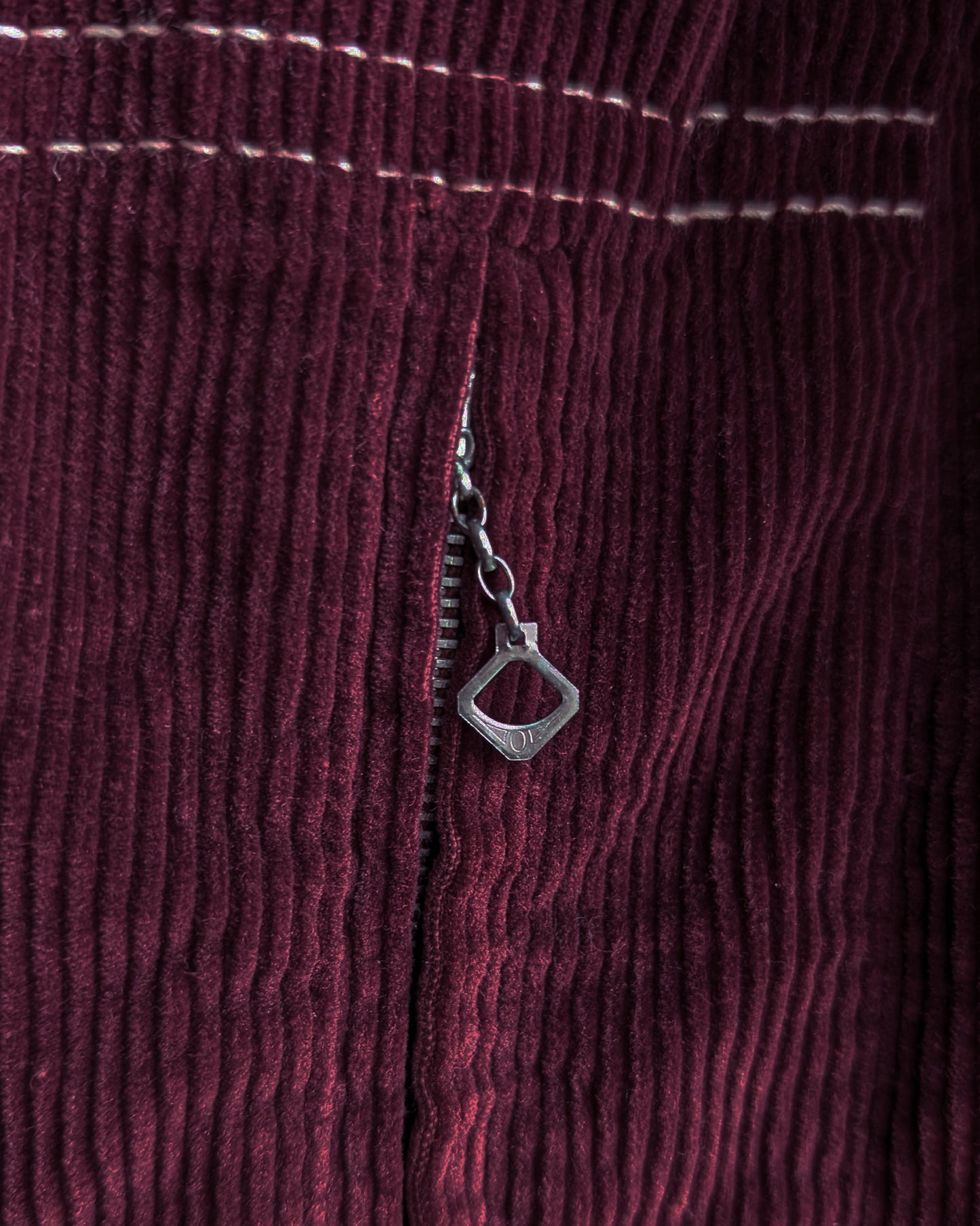 close up of the metal zipper pull on the front pocket