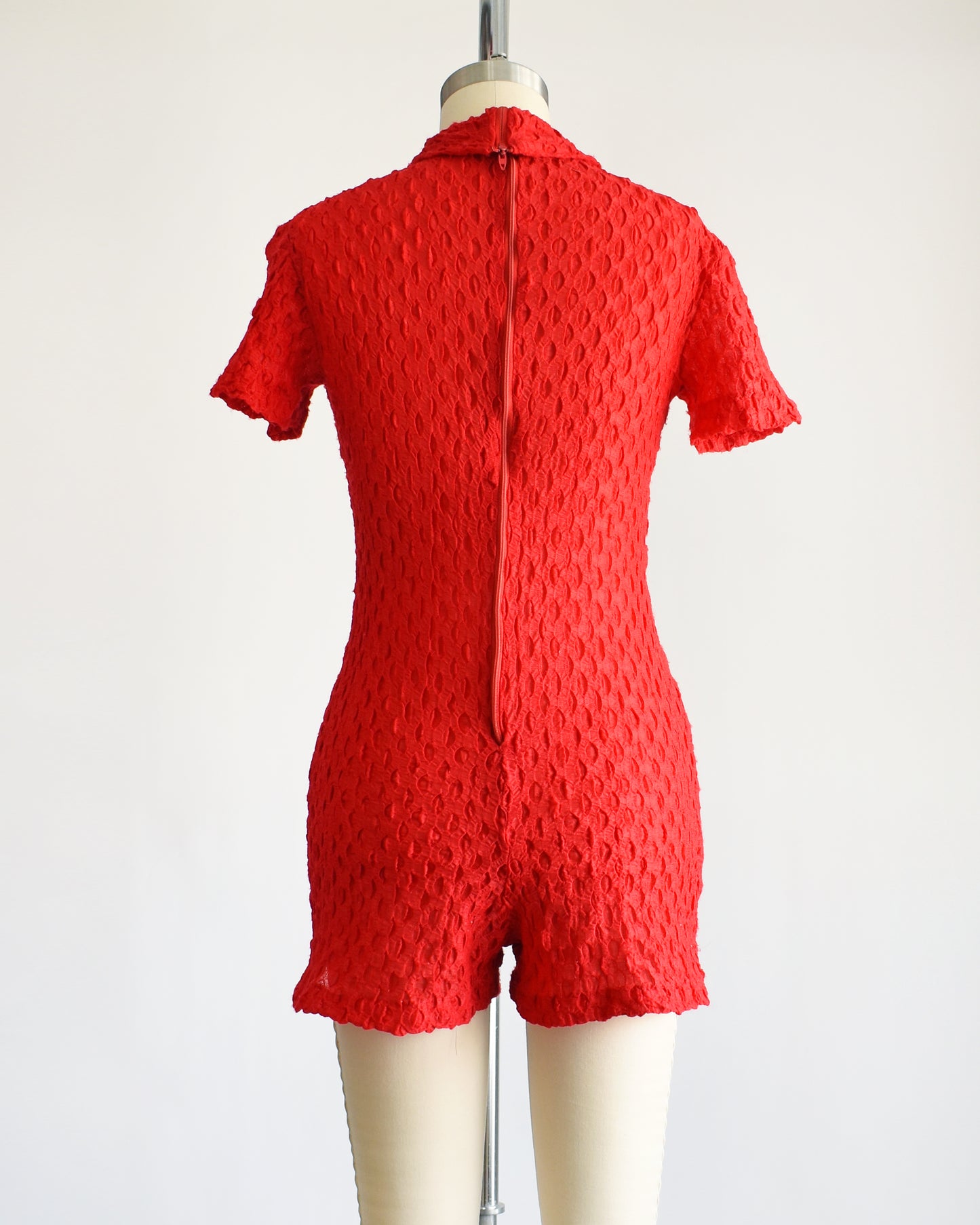 back view of a vintage late 60s early 70s red textured knit bodysuit/romper