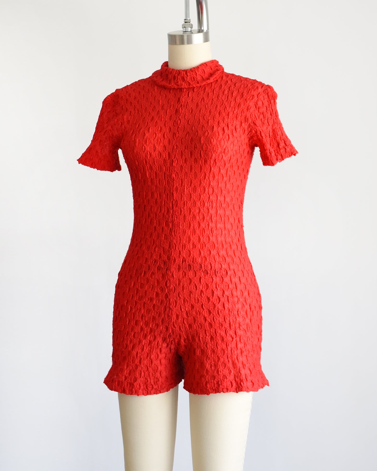 side front view of a vintage late 60s early 70s red textured knit bodysuit/romper