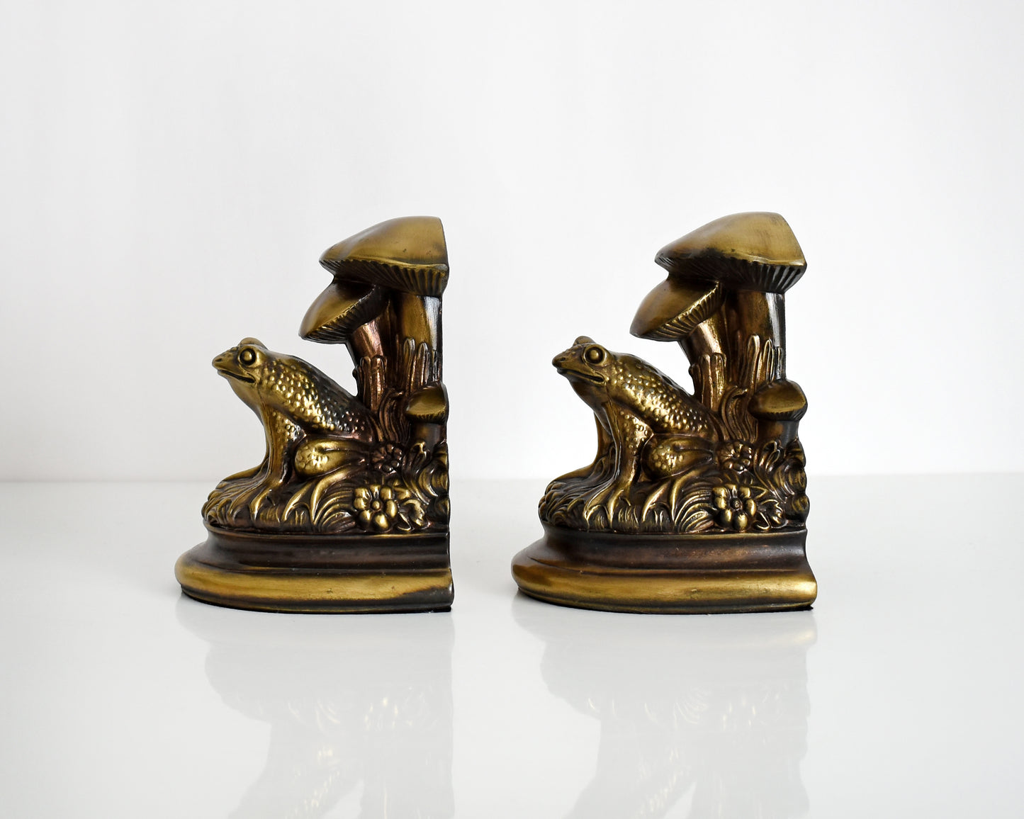 Side view of vintage brass frog and mushroom bookends