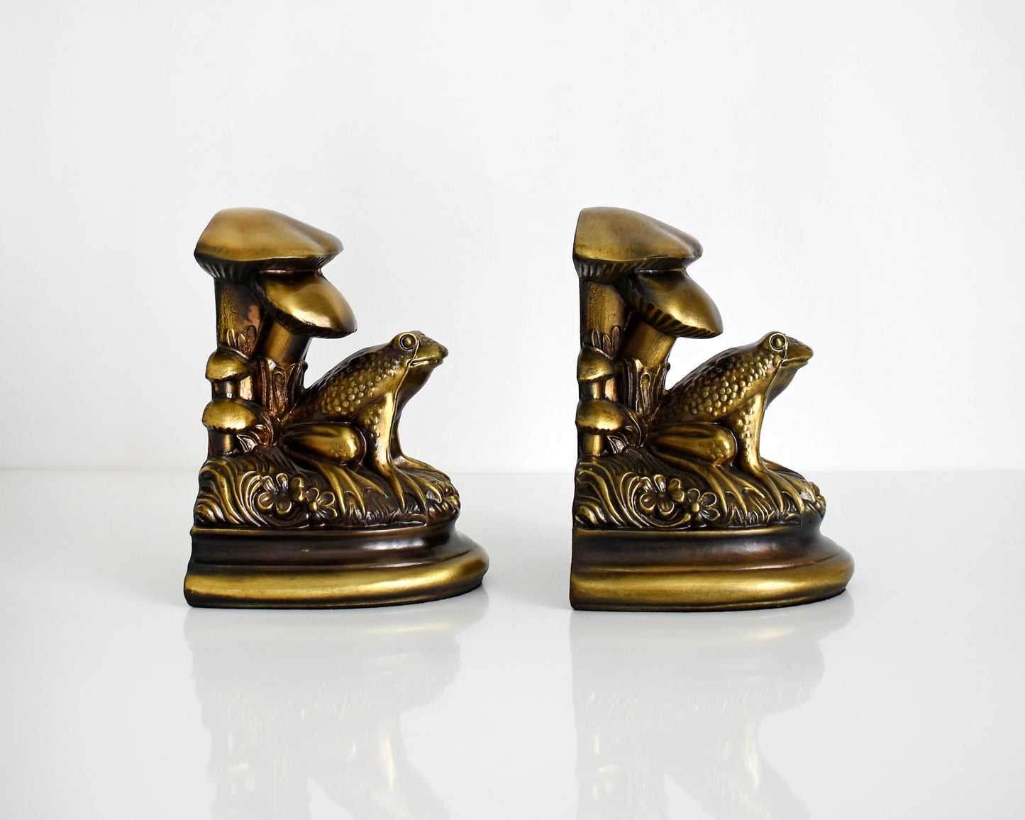 Side view of vintage brass frog and mushroom bookends