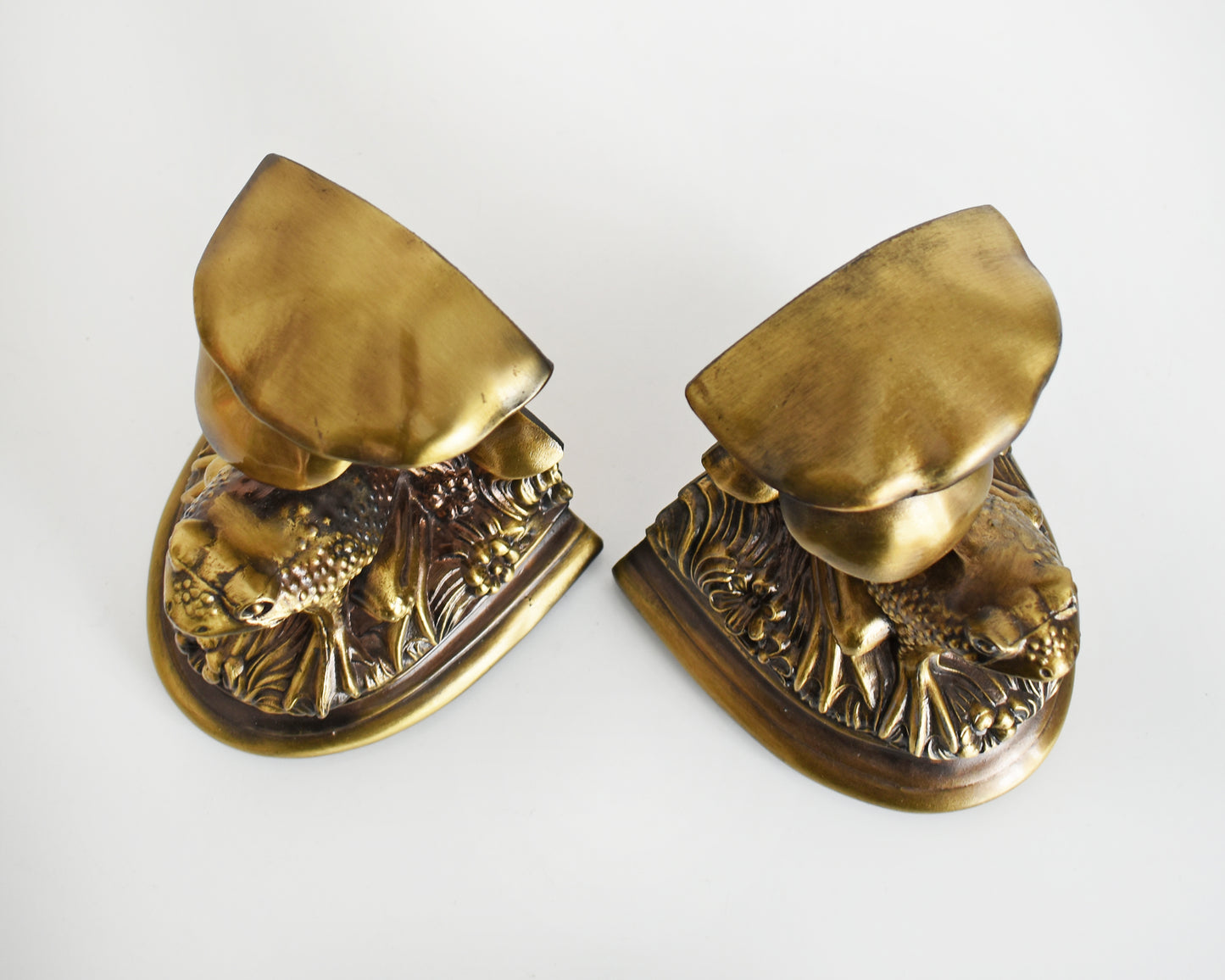 Overhead shot of the top of vintage brass frog and mushroom bookends