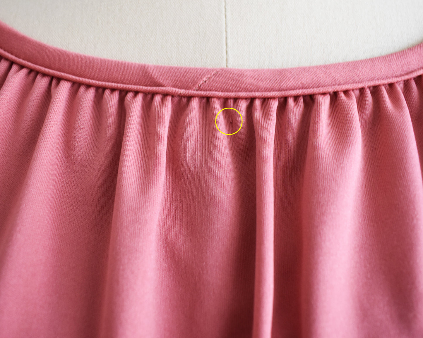 A small pin hole under the collar