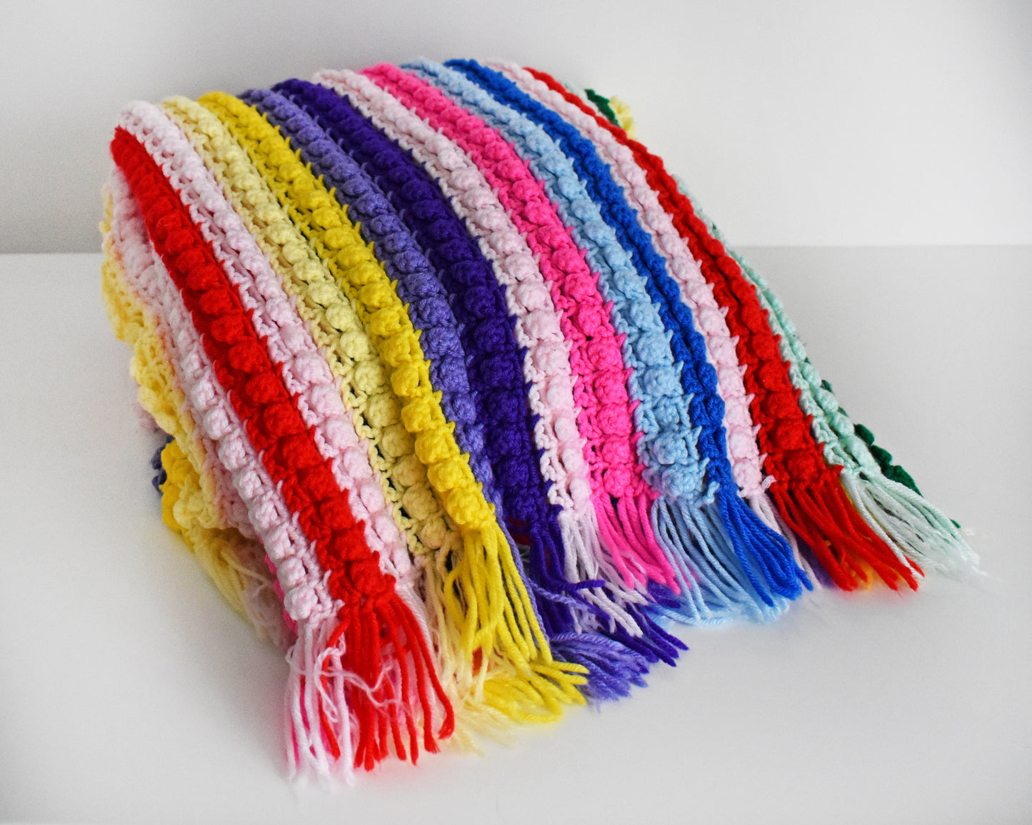 a vintage rainbow striped blanket folded on a white table