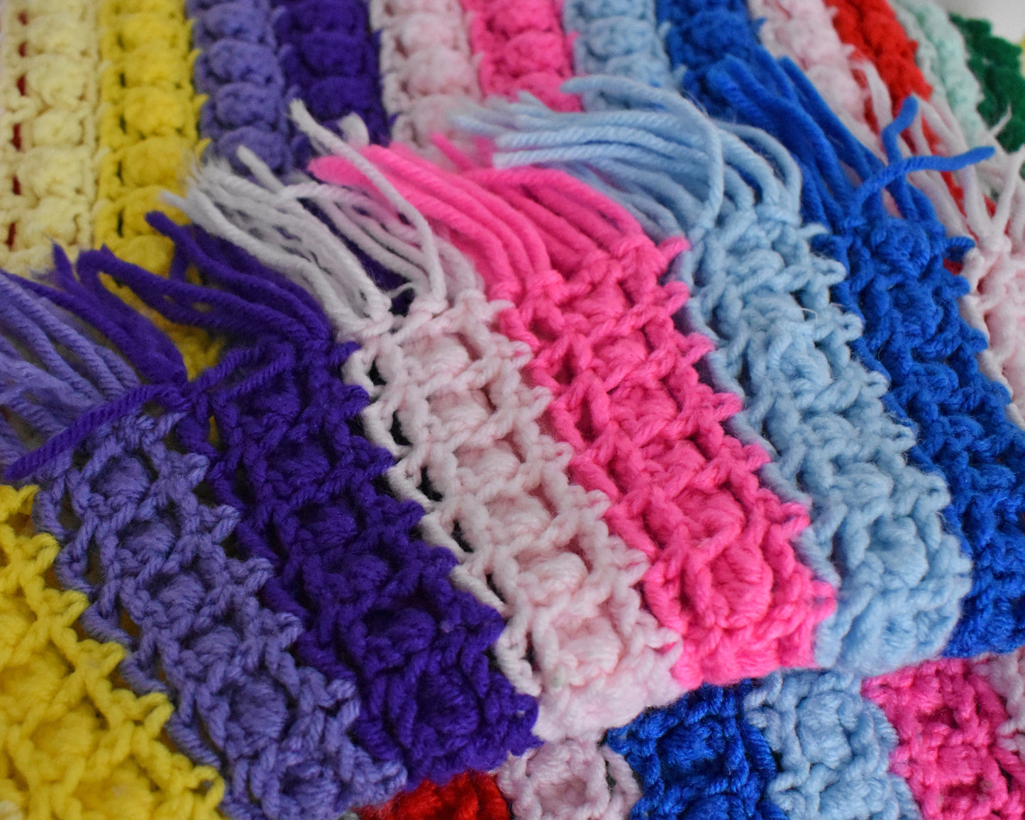 a vintage rainbow striped blanket folded to show the underside