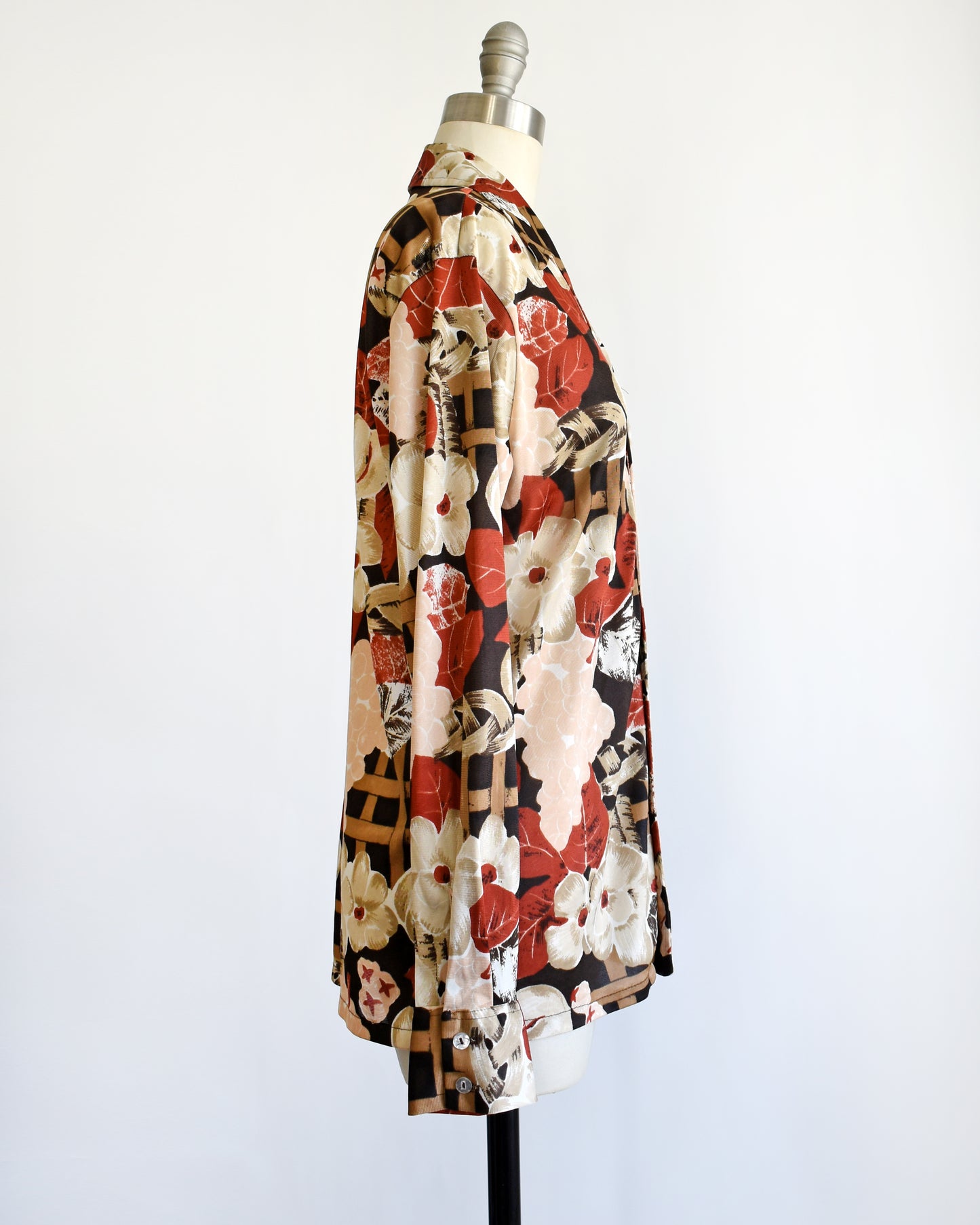 side view of a vintage 1970s fruit and florals disco shirt on a dress form