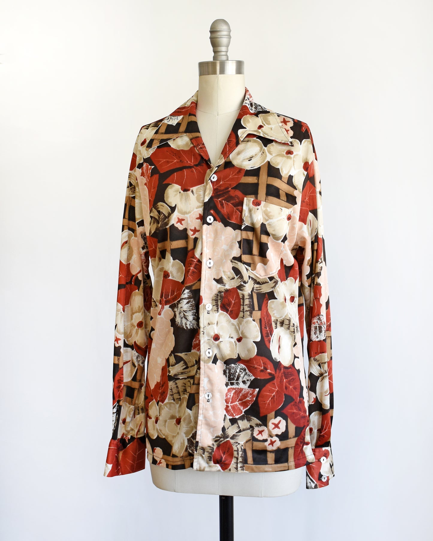 side front view of a vintage 1970s fruit and florals disco shirt on a dress form
