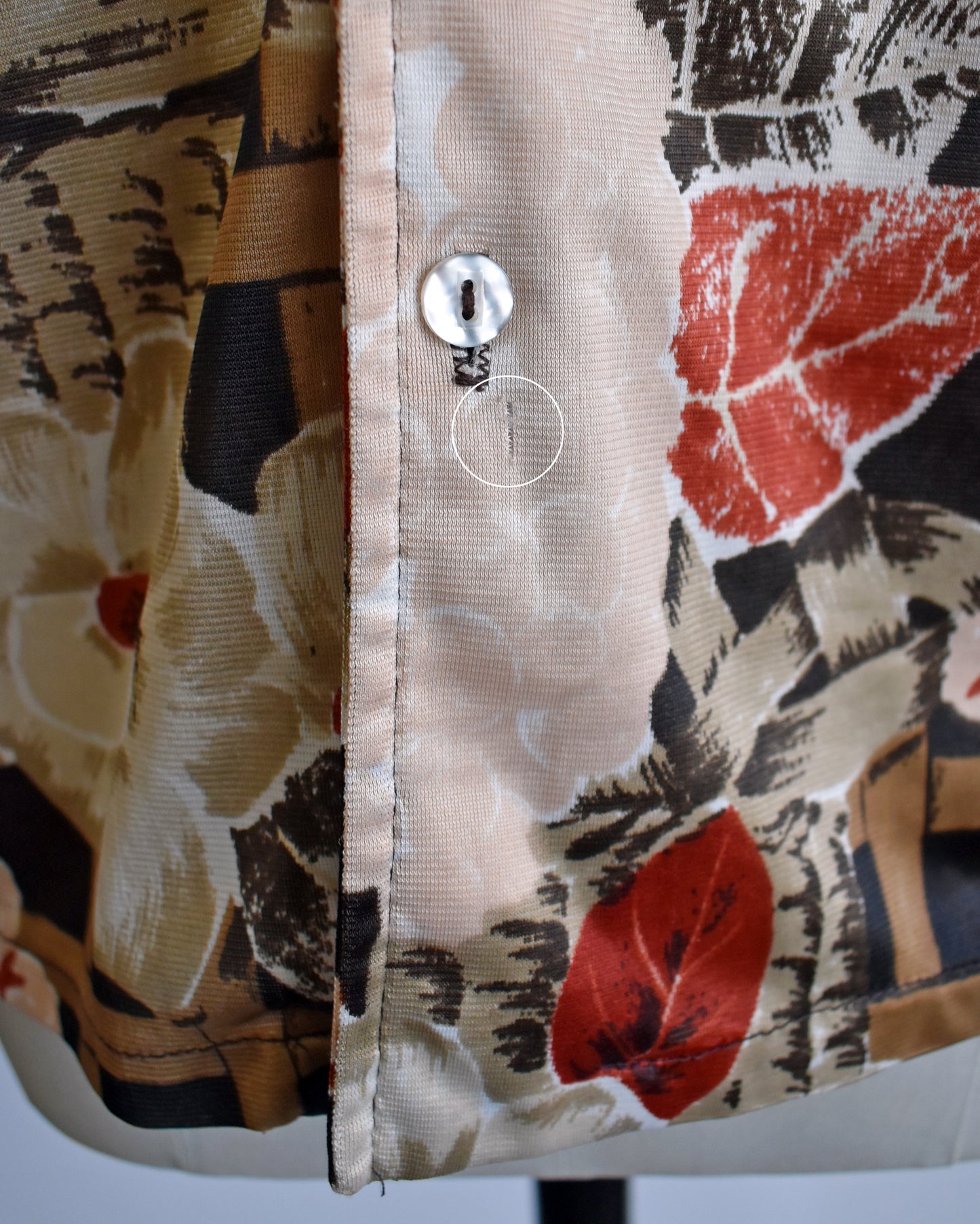 close up of a small run under the last button