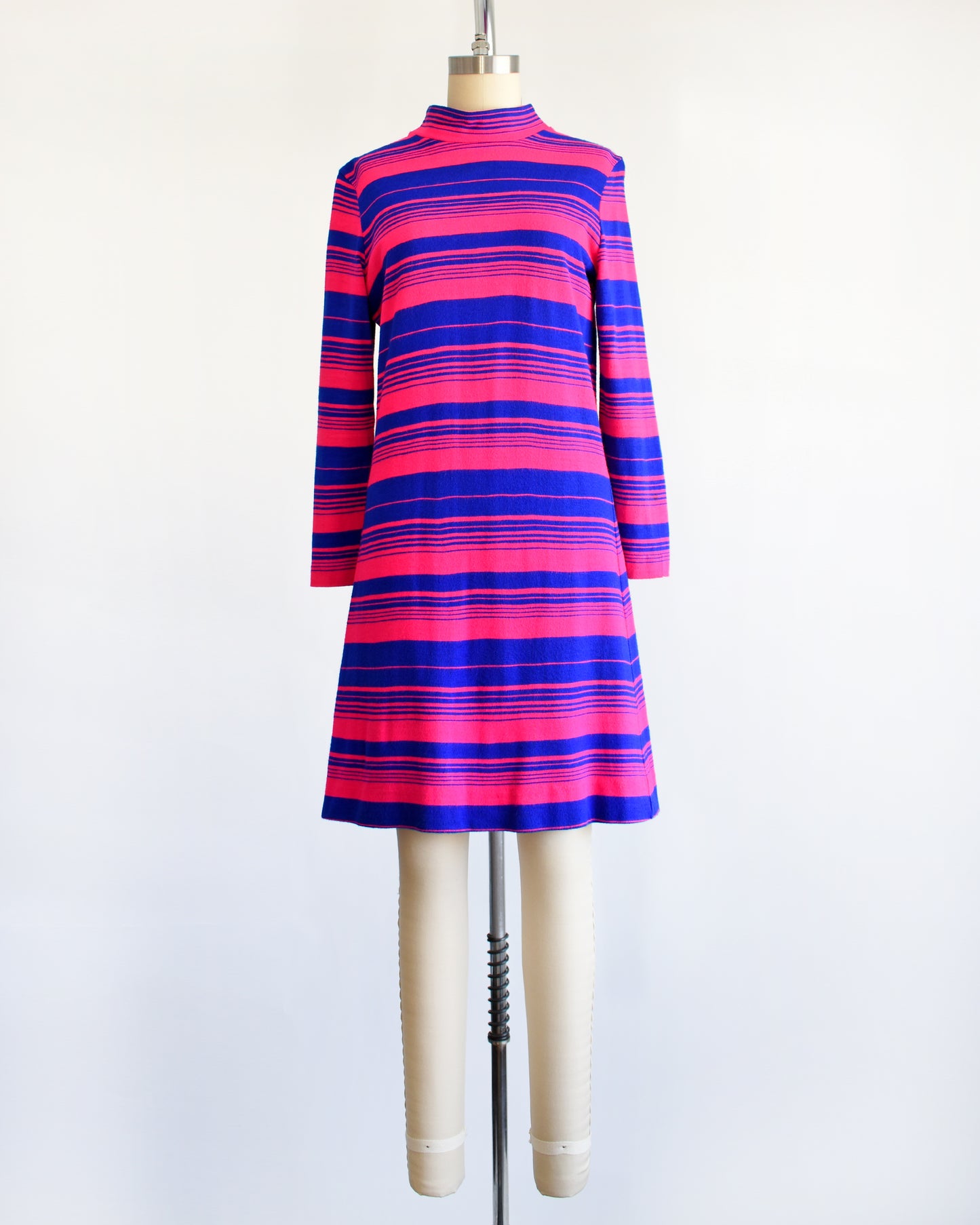 a vintage 1960s pink and blue horizontal mod dress on a dress form