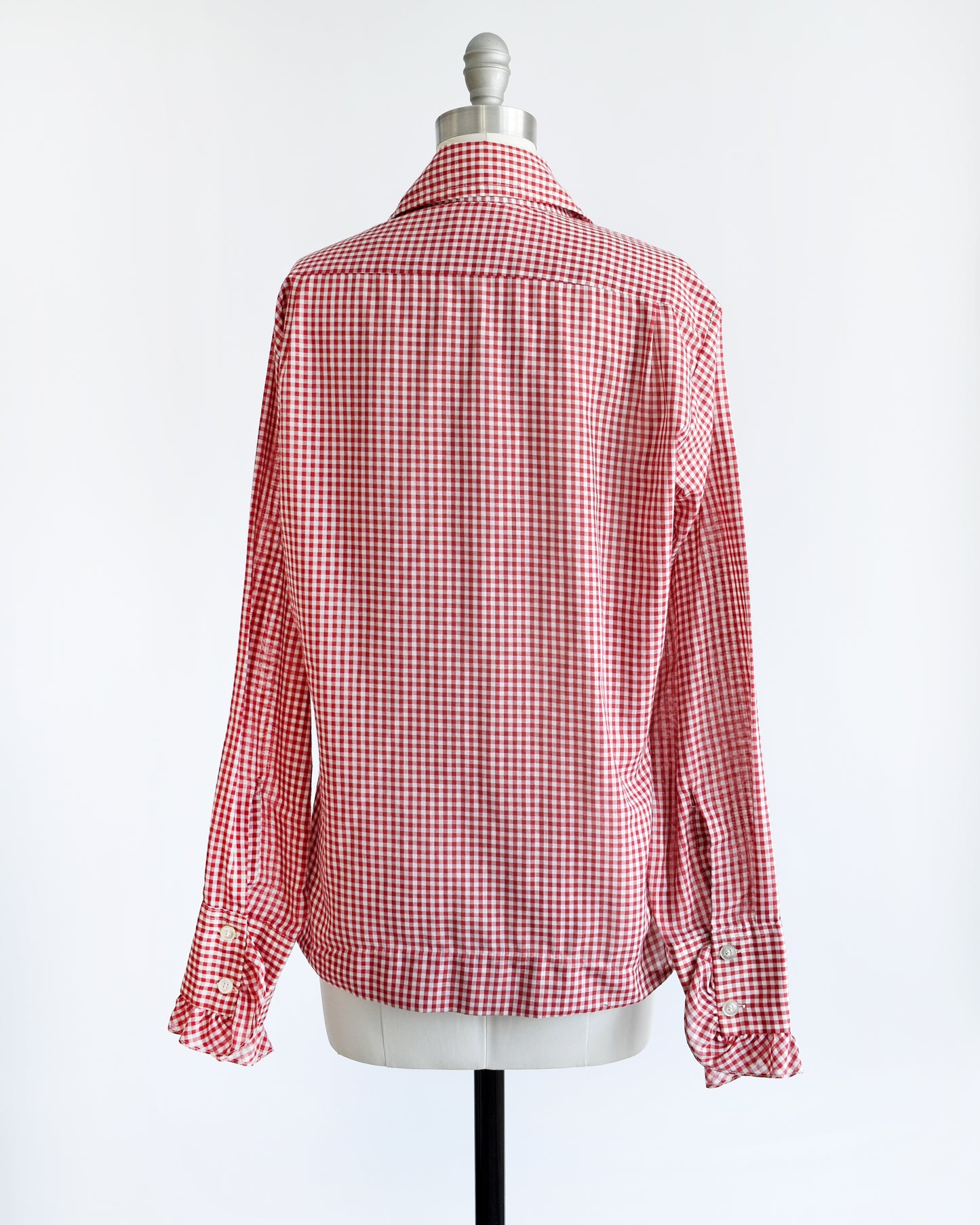 Back view of a vintage 1970s red and white gingham check with tow plastic buttons on the ruffled cuffs
