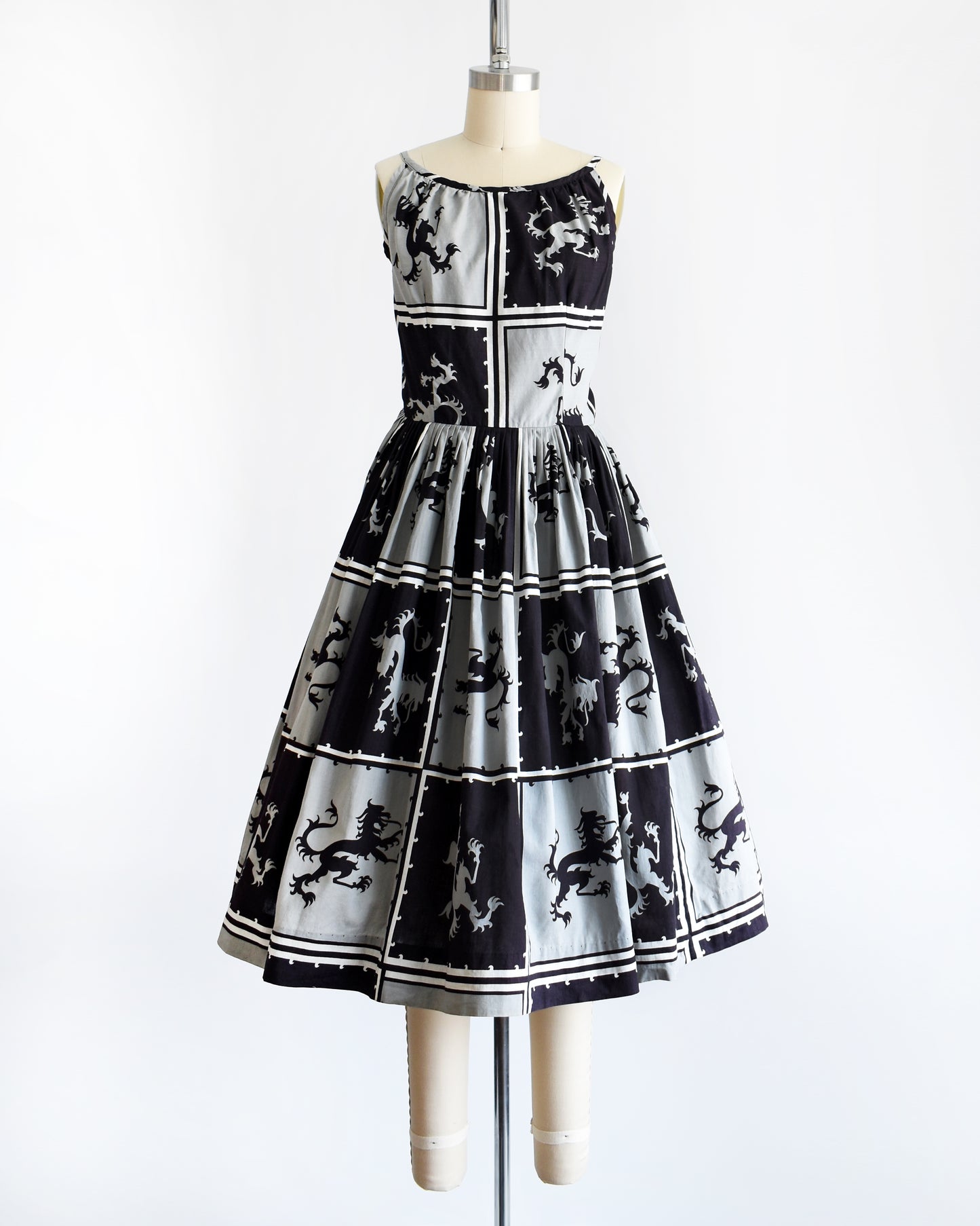 A vintage 1950s that has a black and light gray checkered pattern with a Scottish lion in each center, framed by black and white stripes.