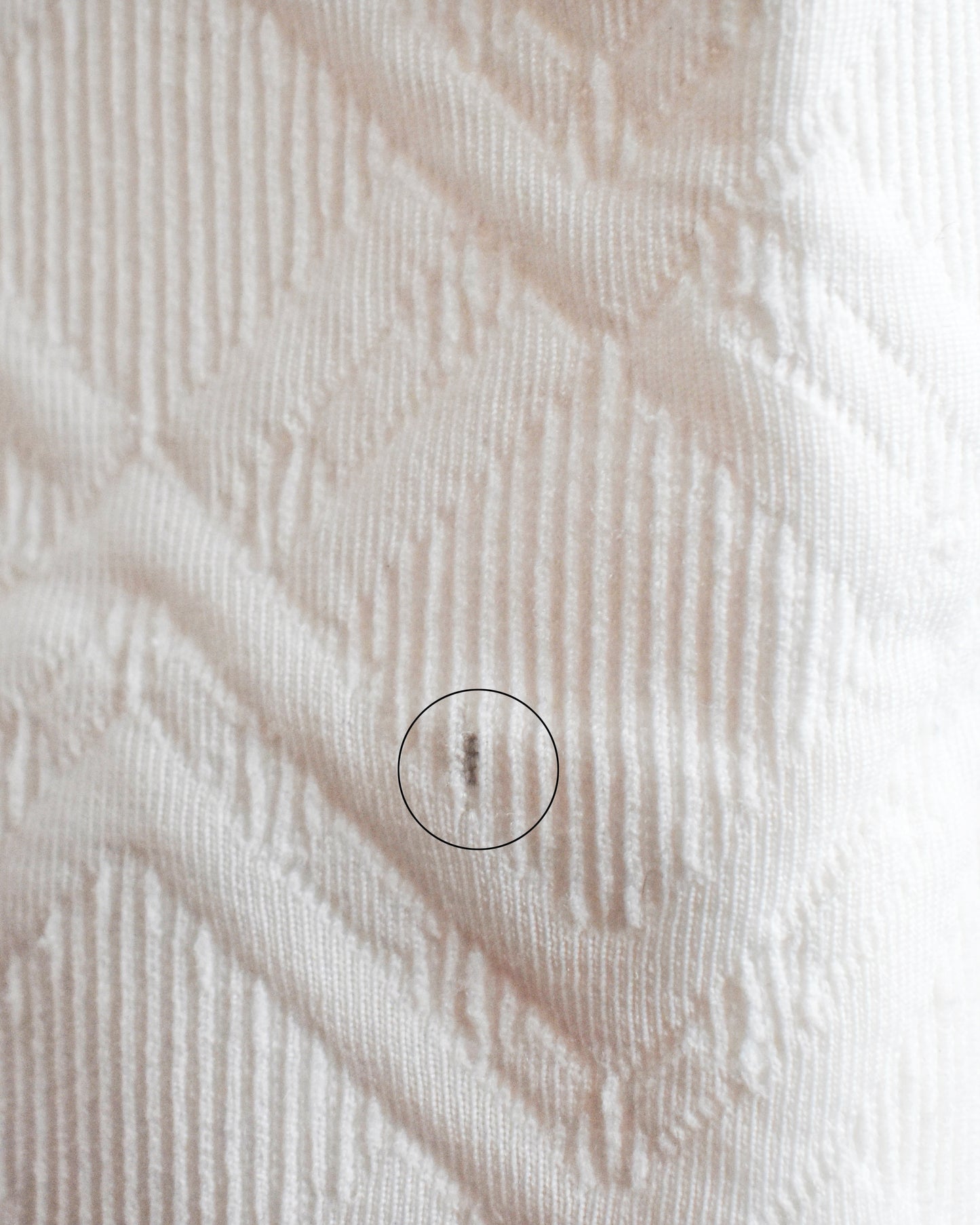 a small dark spot on one of the cuffs