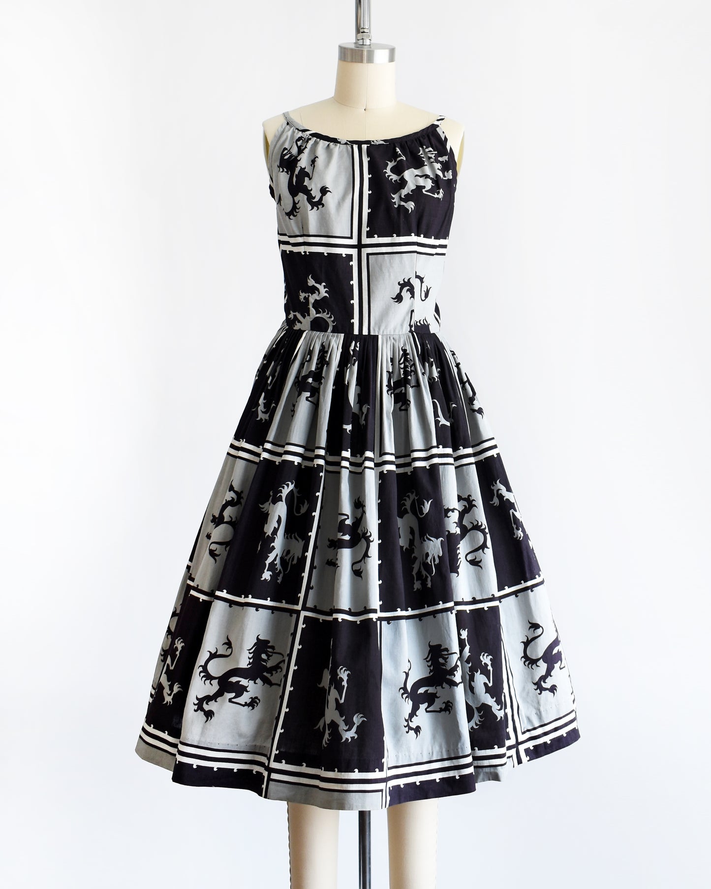 A vintage 1950s that has a black and light gray checkered pattern with a Scottish lion in each center, framed by black and white stripes.