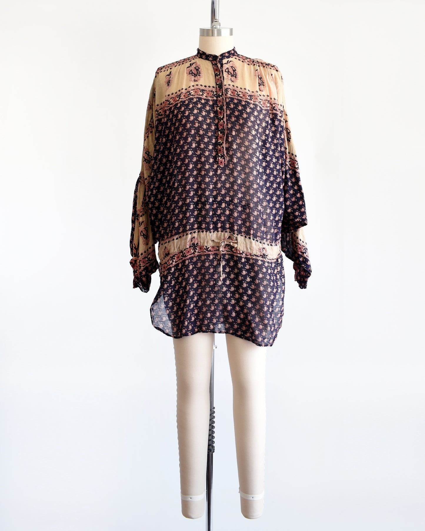 A vintage 1970s Indian cotton tunic made from thin, gauzy navy blue and light tan cotton with a red and navy floral block print
