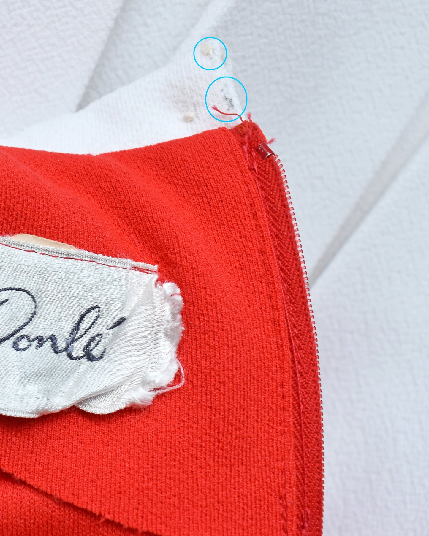 Close up of dark marks on the inside of the collar and missing hook loop