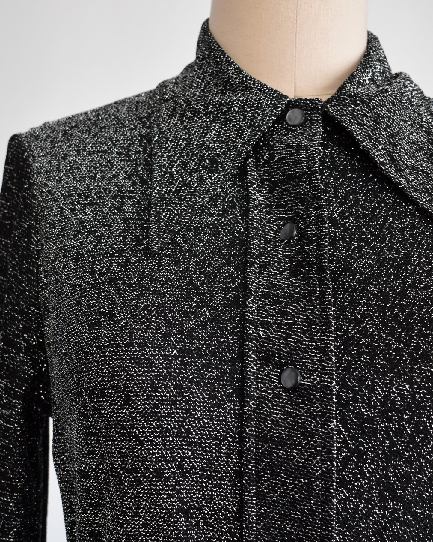 close up of the bodice of a shimmery vintage 1970s metallic maxi dress