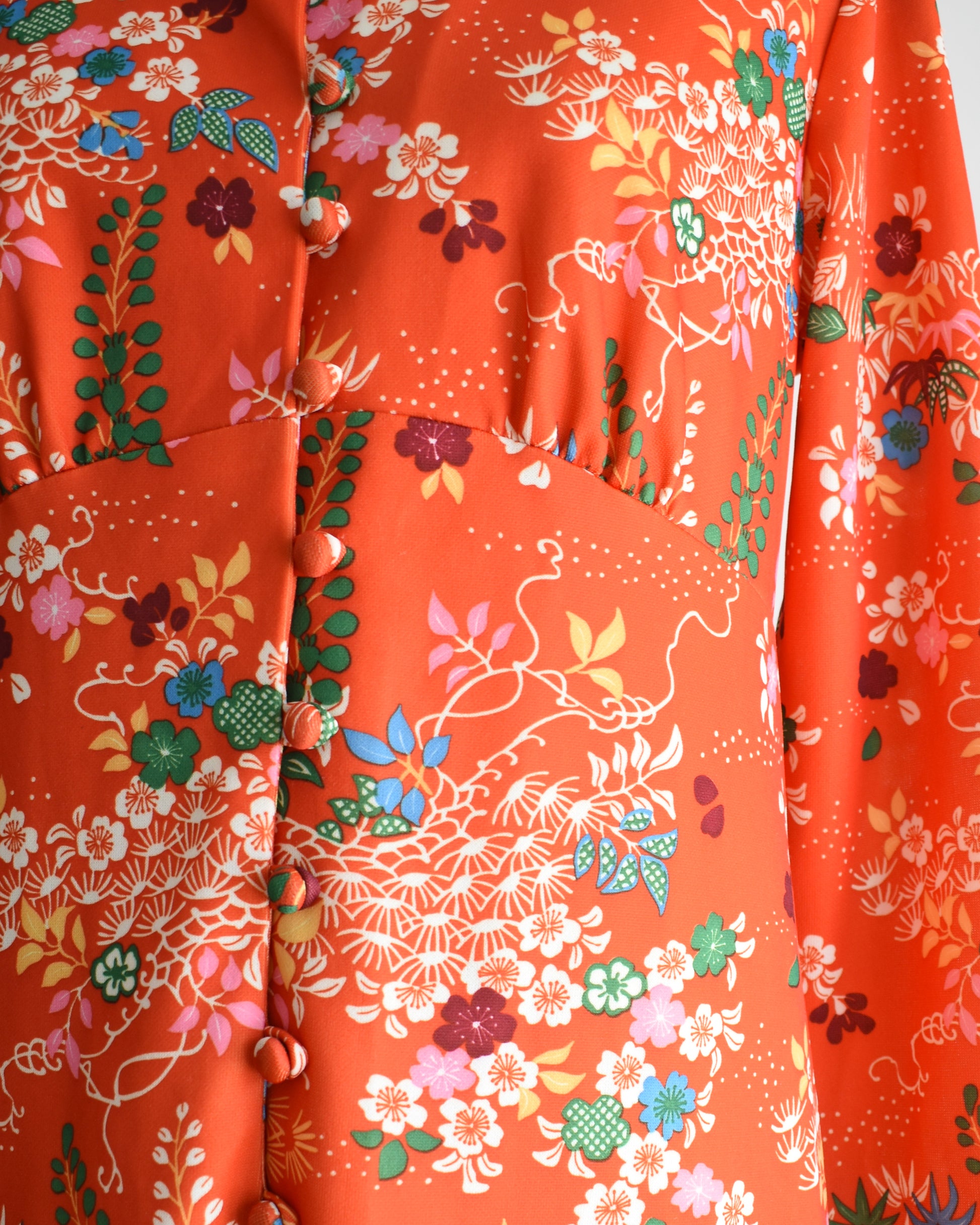 Close up of the floral print, buttons, and empire waist.