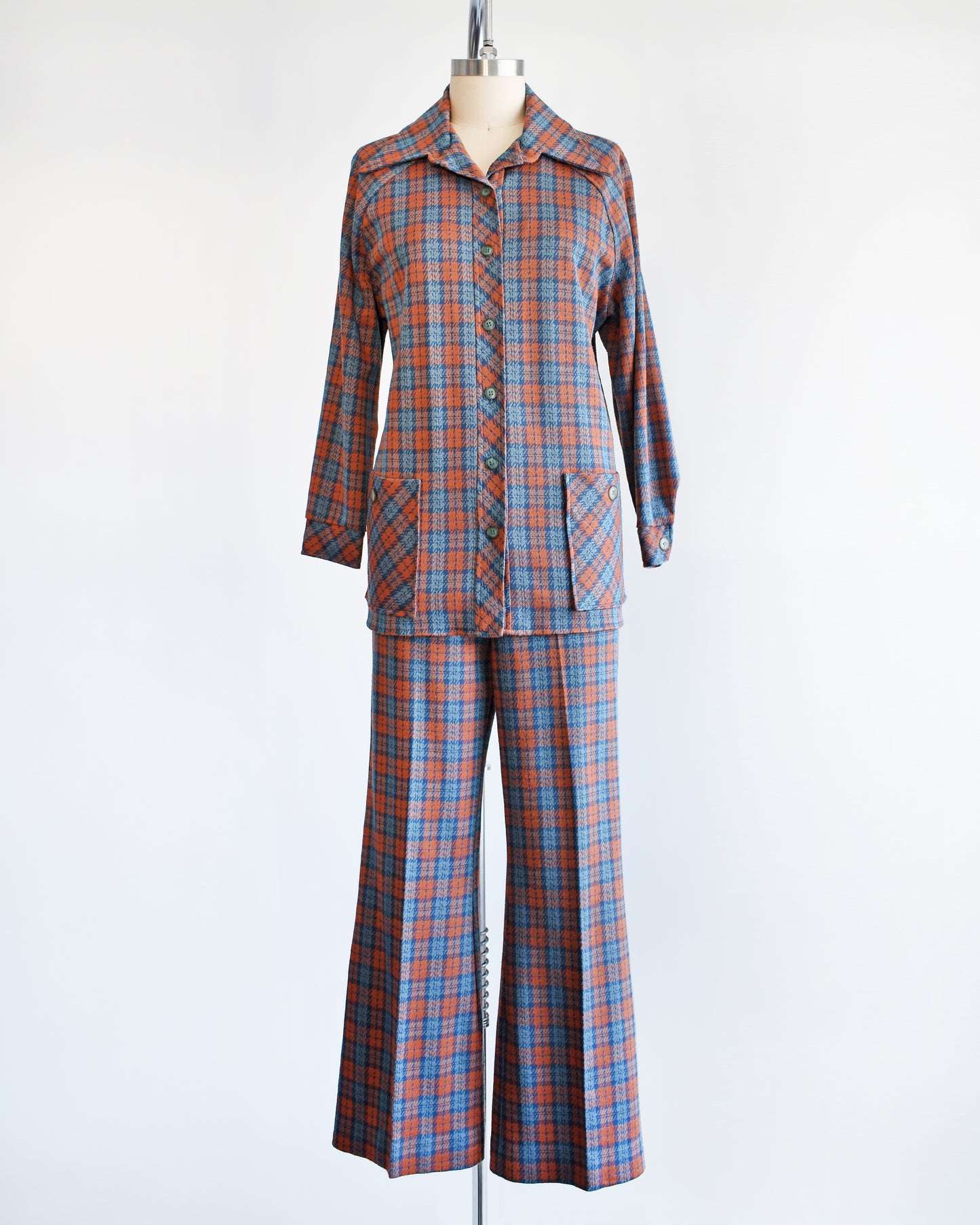 A vintage 1970s blue and orange plaid pantsuit. This set includes a blue and orange plaid long sleeve blouse and matching wide leg pants