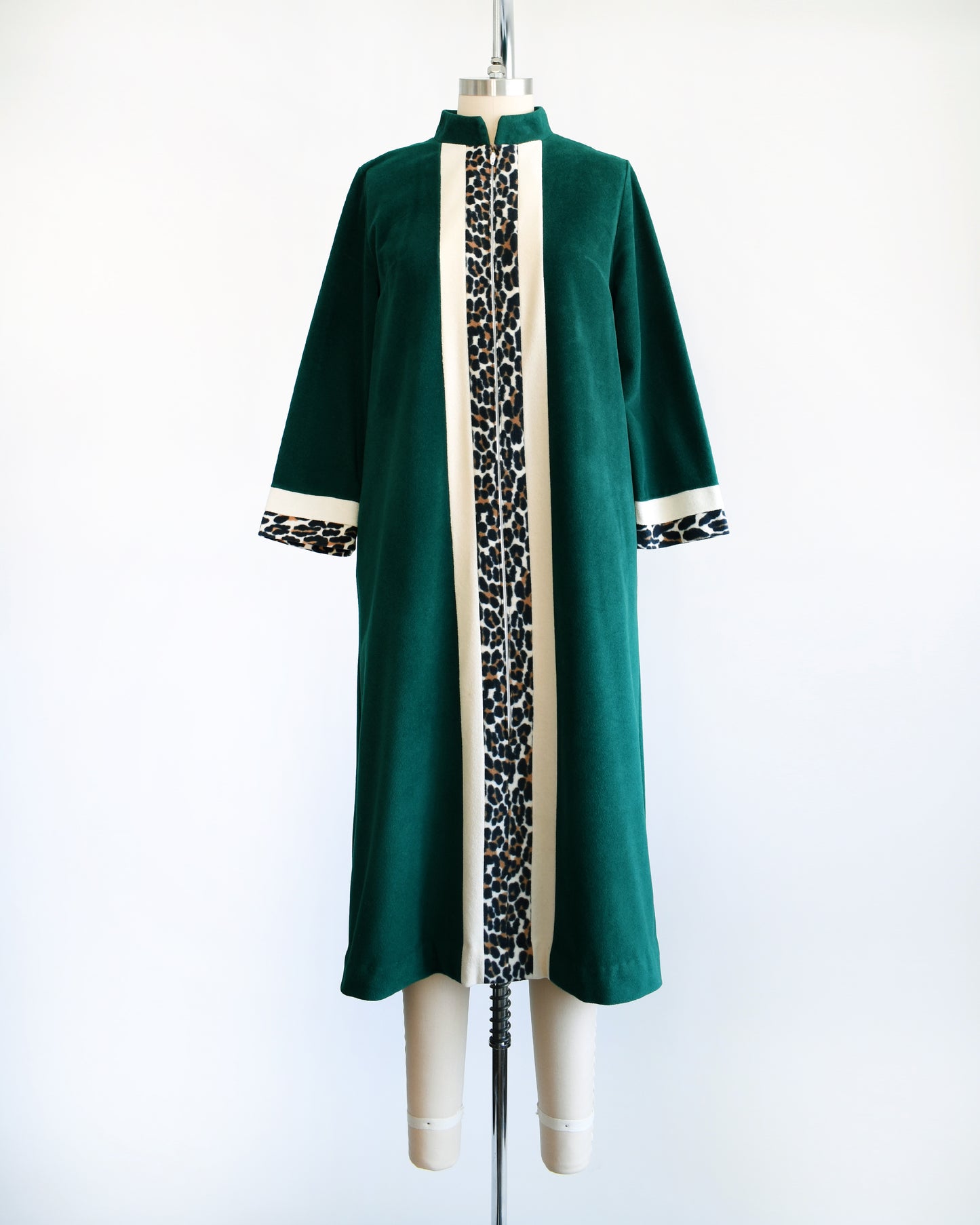 A vintage 1970s robe by Vanity Fair that is a rich dark green with a white and leopard print stripe going down the front and matching stripes on the cuffs.