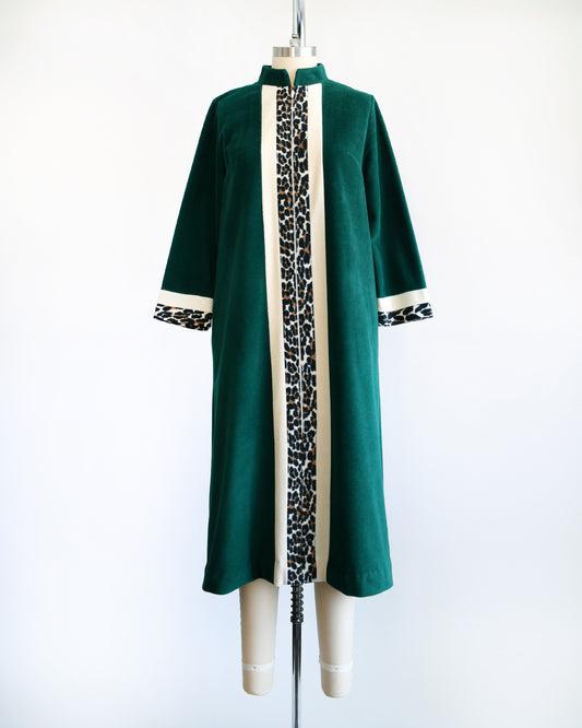 A vintage 1970s robe by Vanity Fair that is a rich dark green with a white and leopard print stripe going down the front and matching stripes on the cuffs.