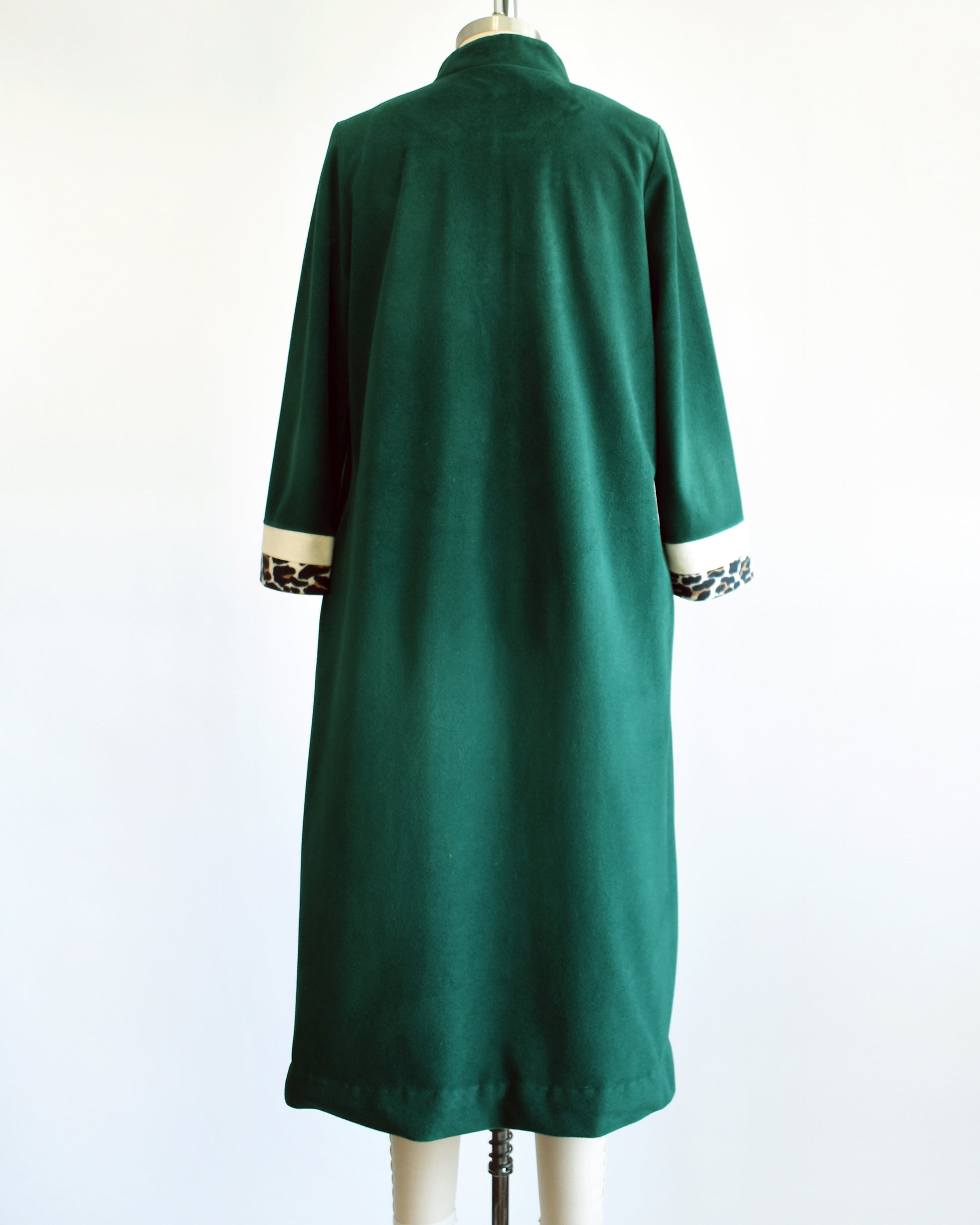 Back view of a vintage 1970s robe by Vanity Fair that is green with white leopard print stripes on the cuffs