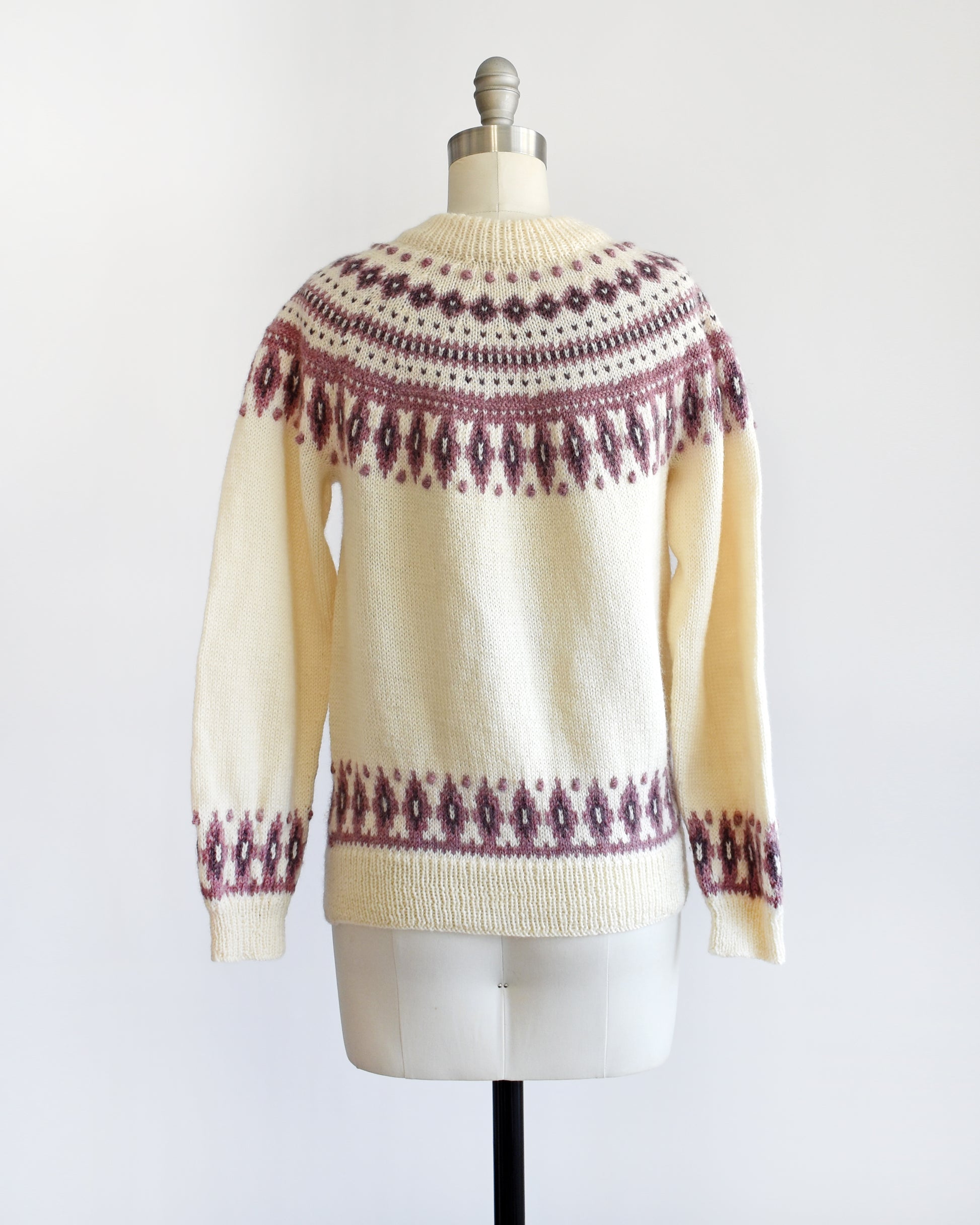 Back view of a vintage 1980s Dale of Norway cream wool sweater that has a purple Fair Isle pattern around the collar that's accented with matching purple nubby details.