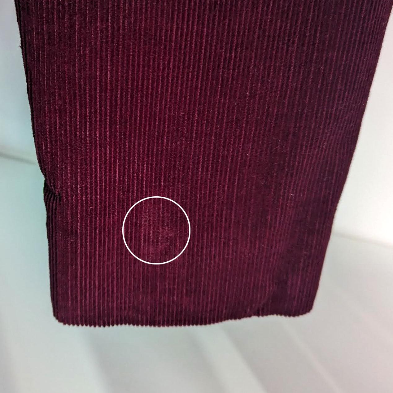 A small worn spot on the left cuff