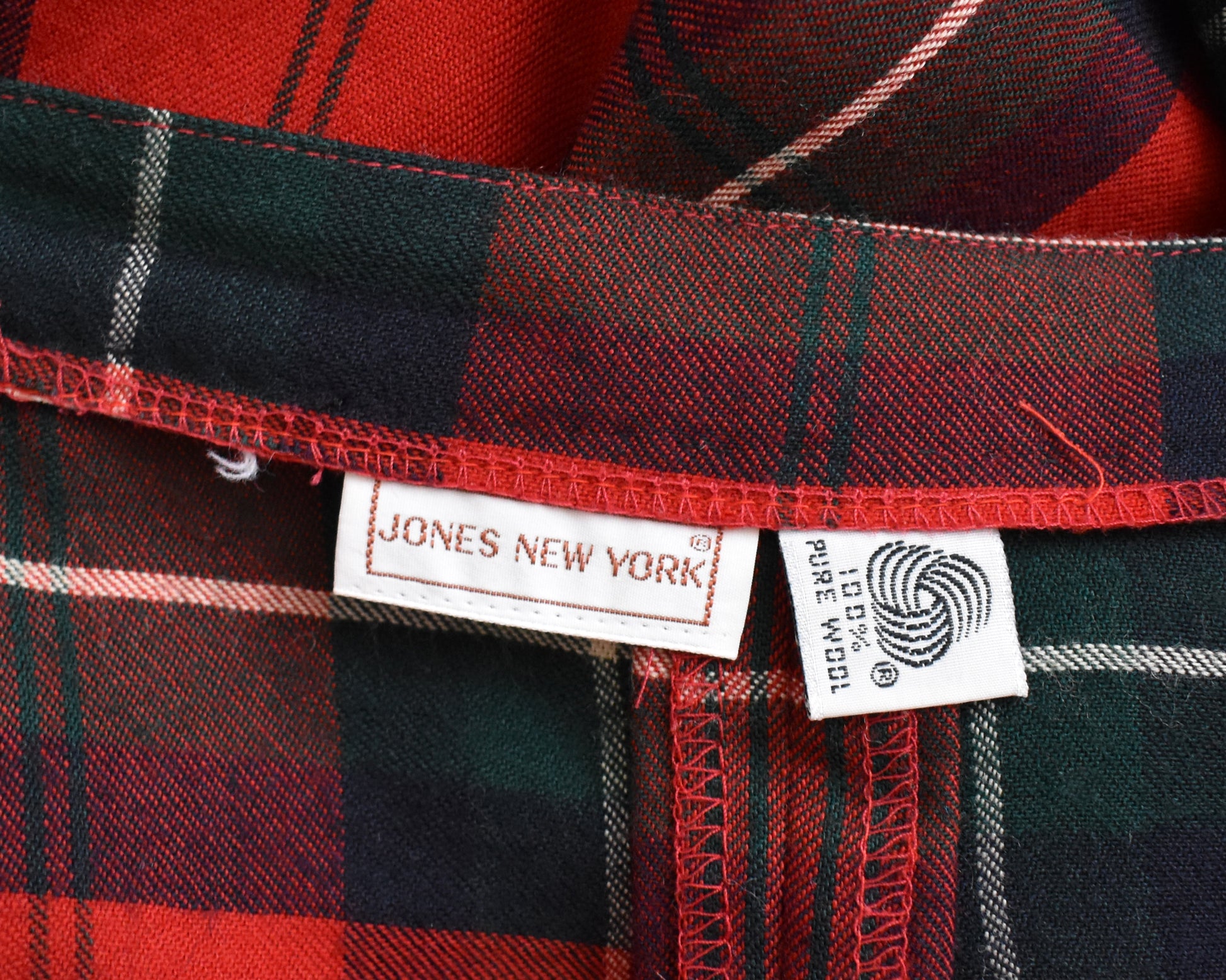 Close up of the Jones New York tag and 100% pure wool tag