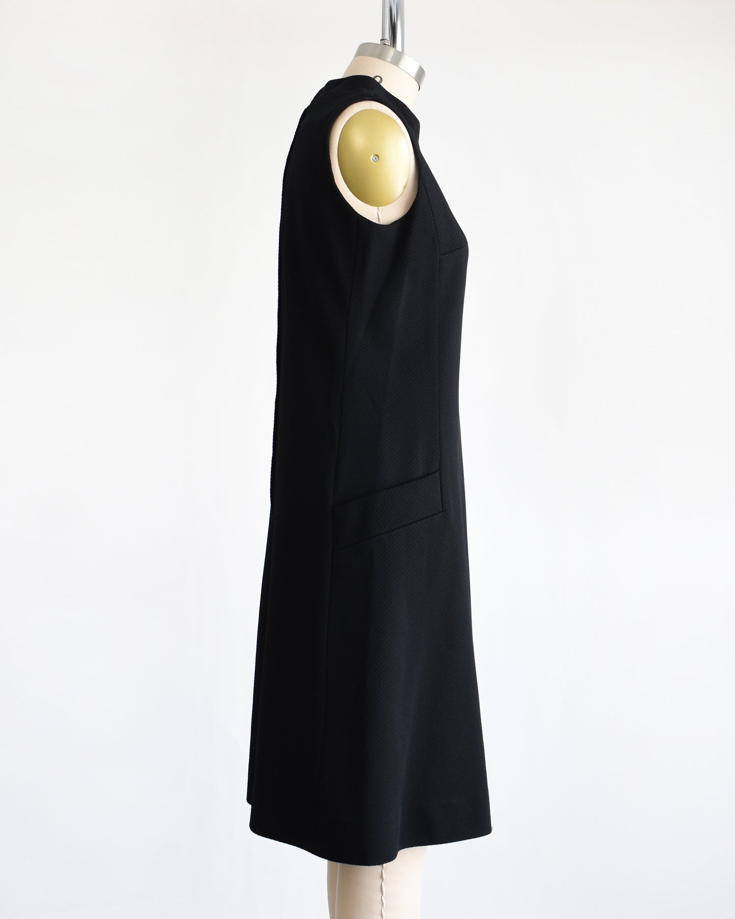 side view of a vintage 1960s black mod scooter dress