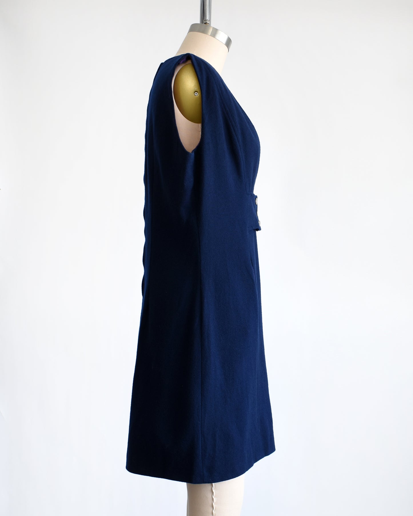 side view of a vintage 1980s navy blue wool jumper dress