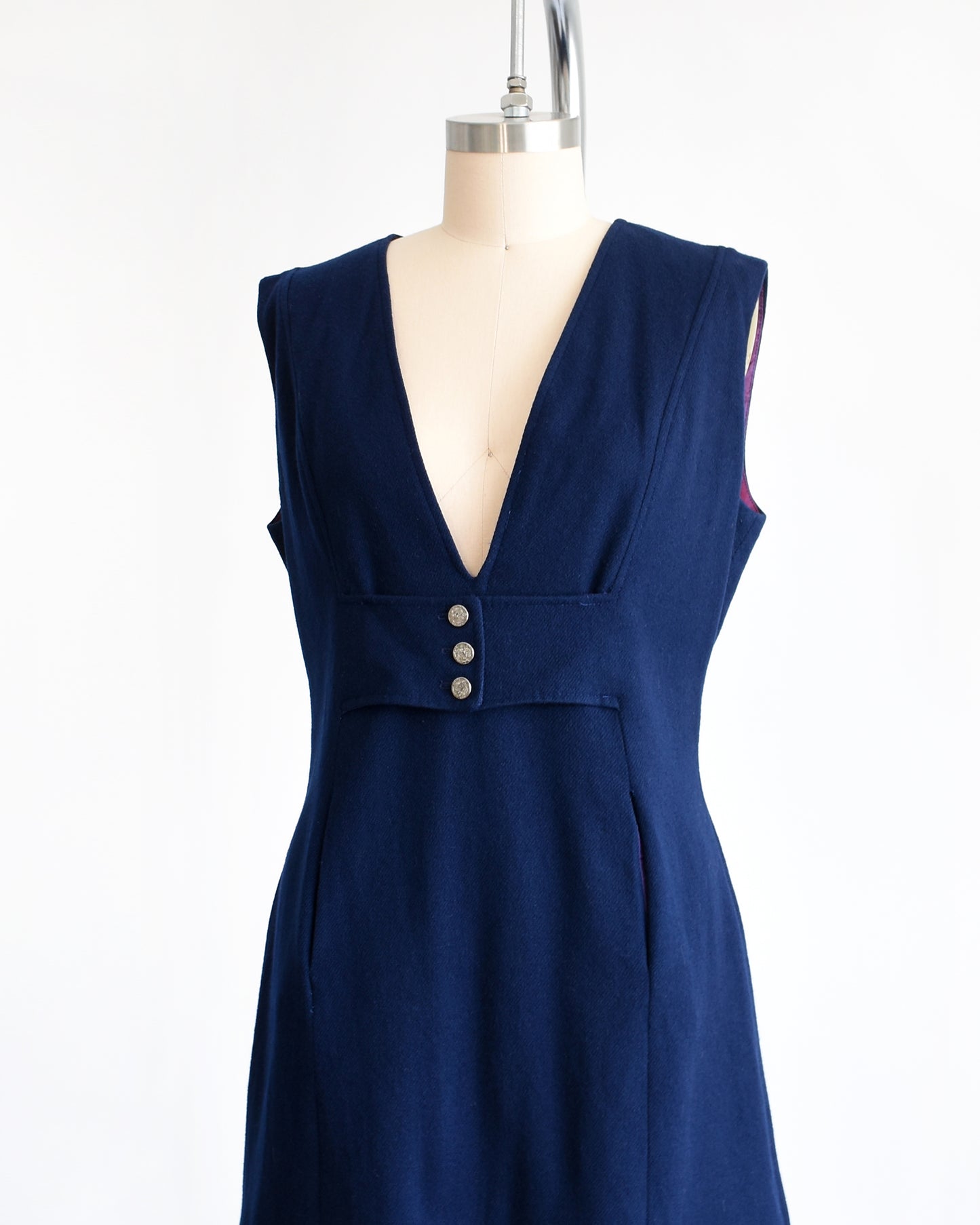 side front view of a vintage 1980s navy blue wool jumper dress