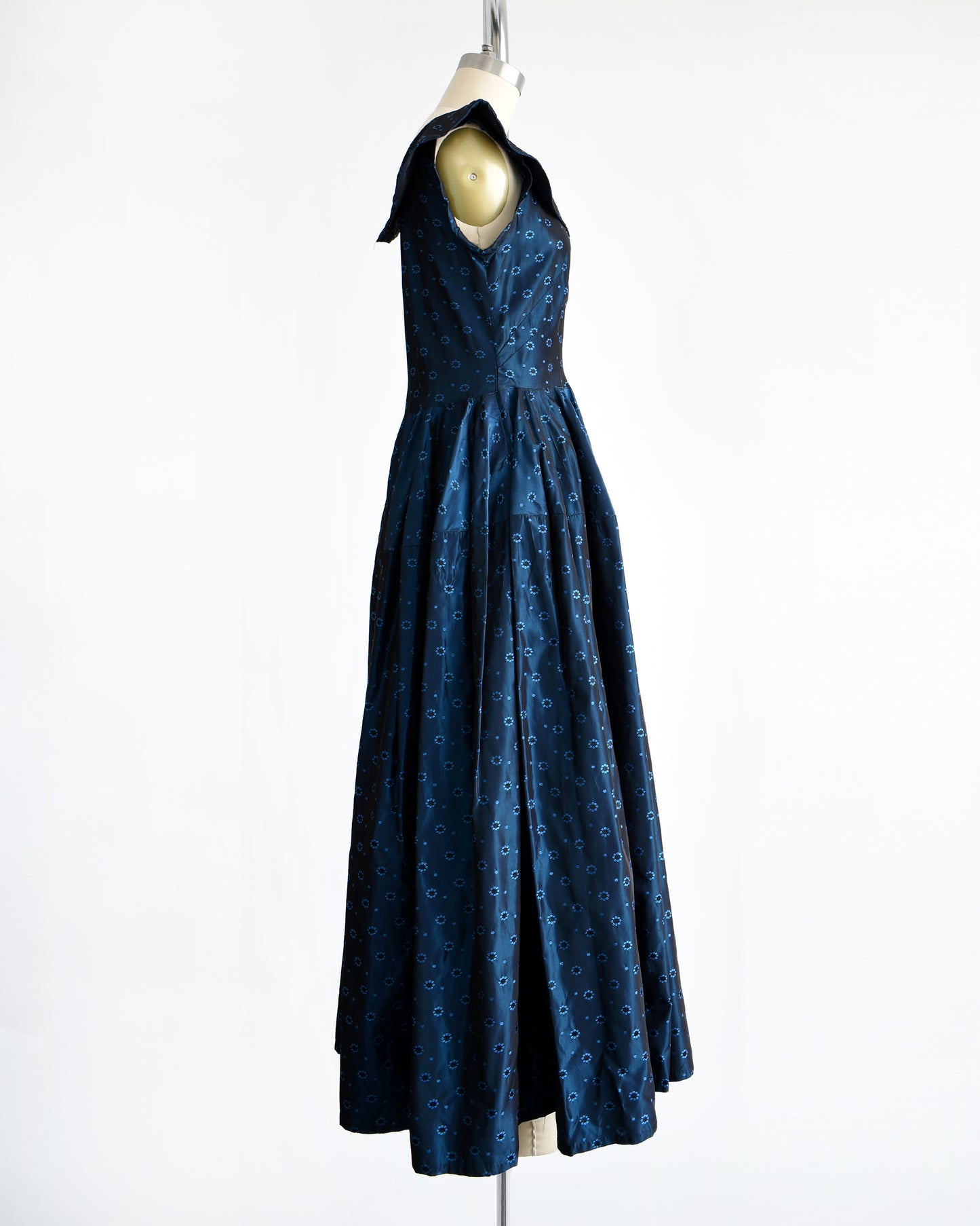 side view of a vintage 1950s blue black floral brocade dress